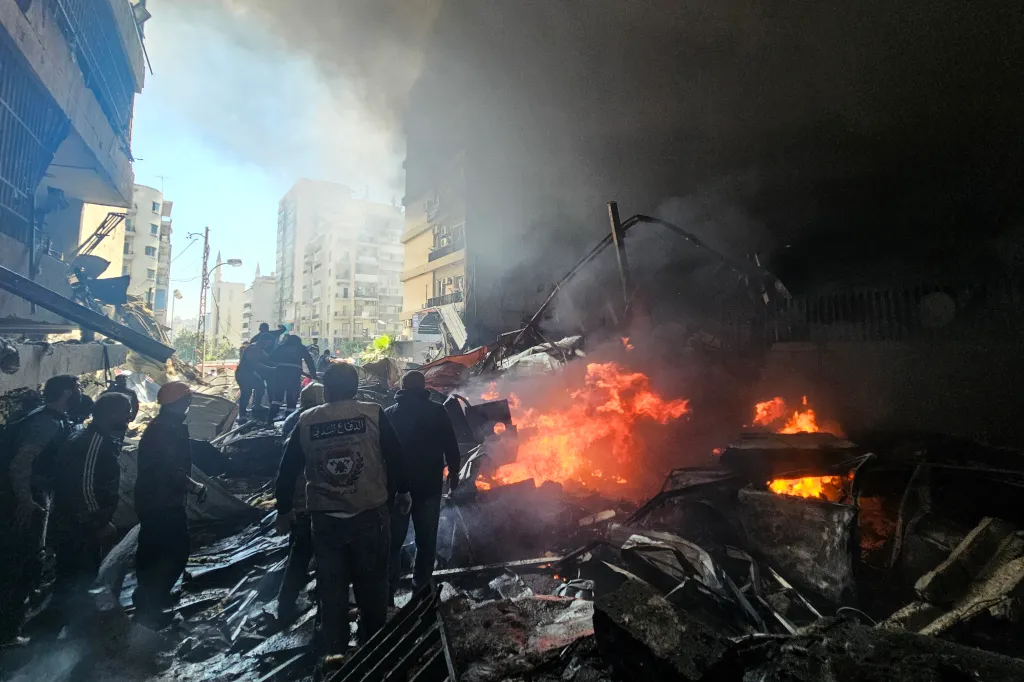 First responders among rubble with fires blazing after an Israeli airstrike in Beirut's Corniche al-Mazraa neighborhood.