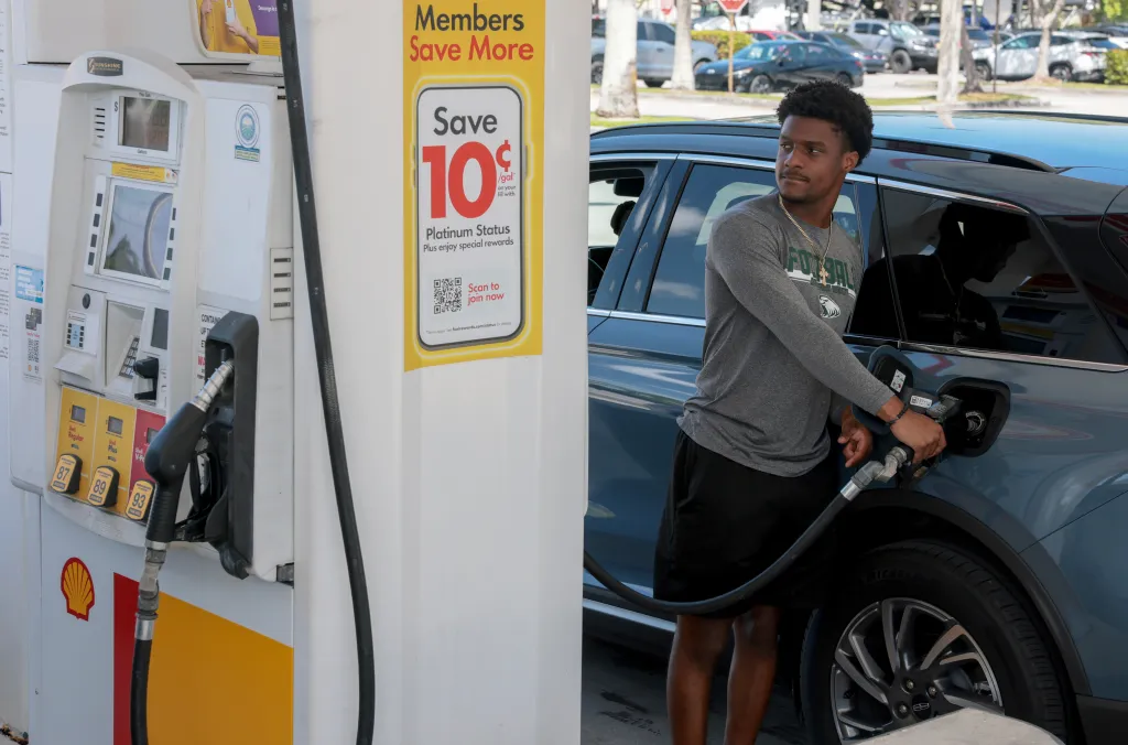 Kyndal Royal fills his vehicle with fuel at a gas station.