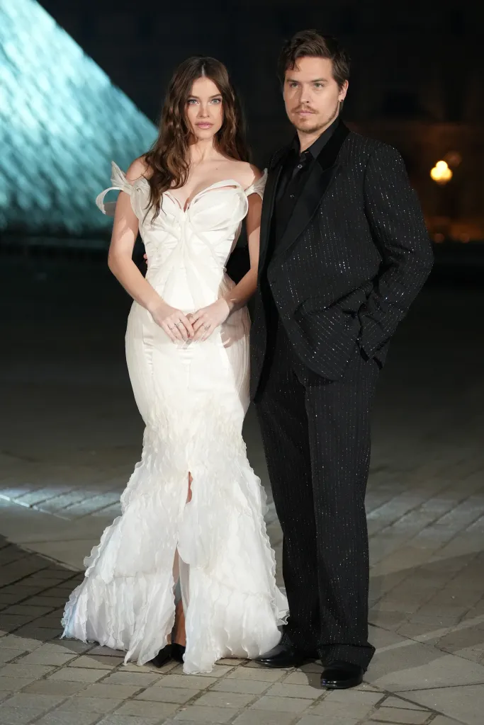 Barbara Sprouse in a white gown and Dylan Sprouse in a black suit.