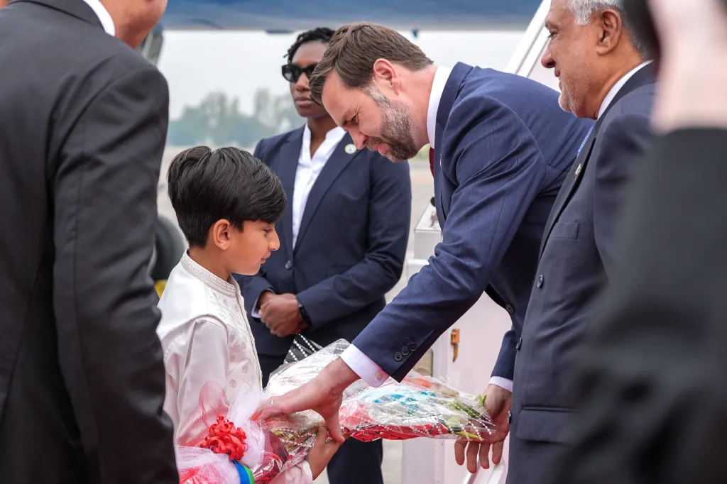 Vice President JD Vance receives a bouquet from a child after stepping off Air Force Two in Islamabad, Pakistan, on April 11, 2026. 