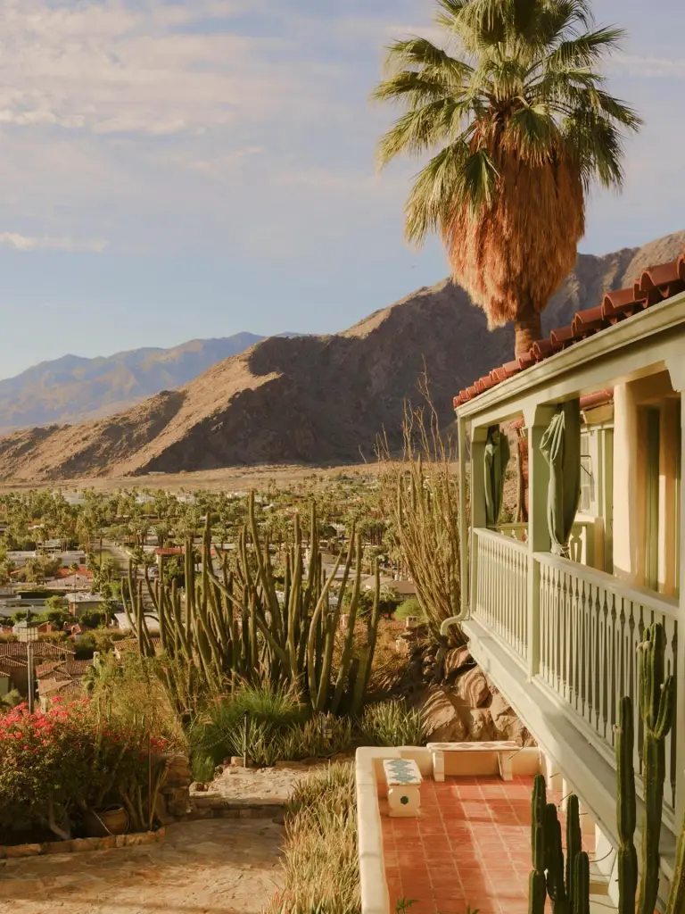 Balcony of the Soho Desert House in Palm Springs with a view of the desert landscape.