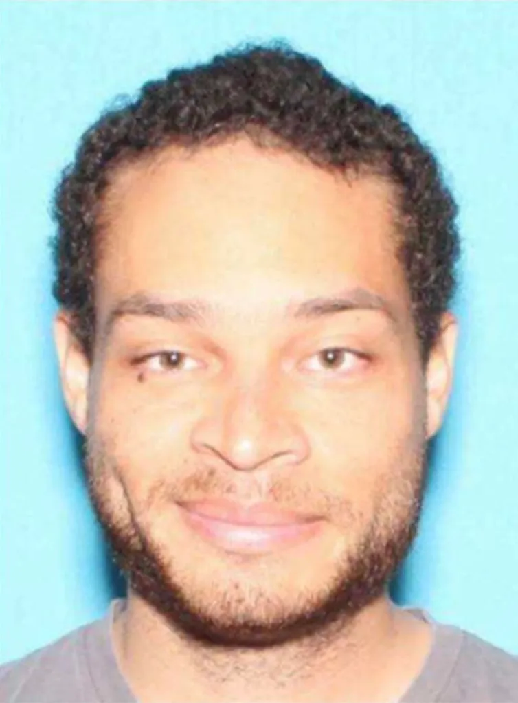 Mugshot of Cole Allen, a man with curly brown hair, brown eyes, and a light beard, smiling slightly.