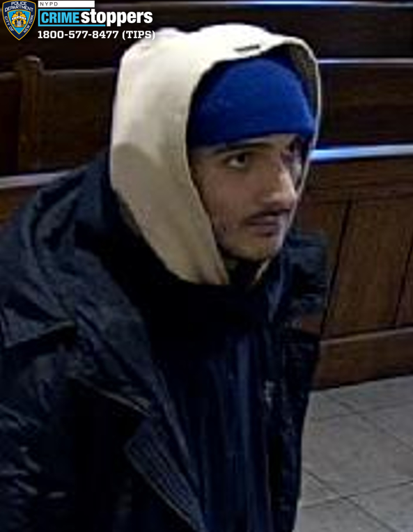 Image of a man wearing a blue hat, light-colored hooded sweatshirt, and black jacket, wanted in connection with an aggravated harassment incident.