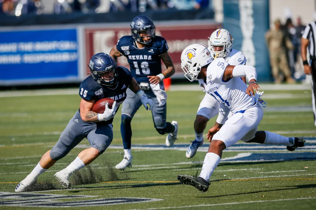 Nevada Wolf Pack running back #35 Toa Taua cuts past San Jose State Spartans linebacker #41 Hadari Darden.