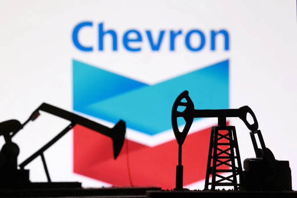 Illustration of 3D-printed oil pump jacks in front of the Chevron logo.