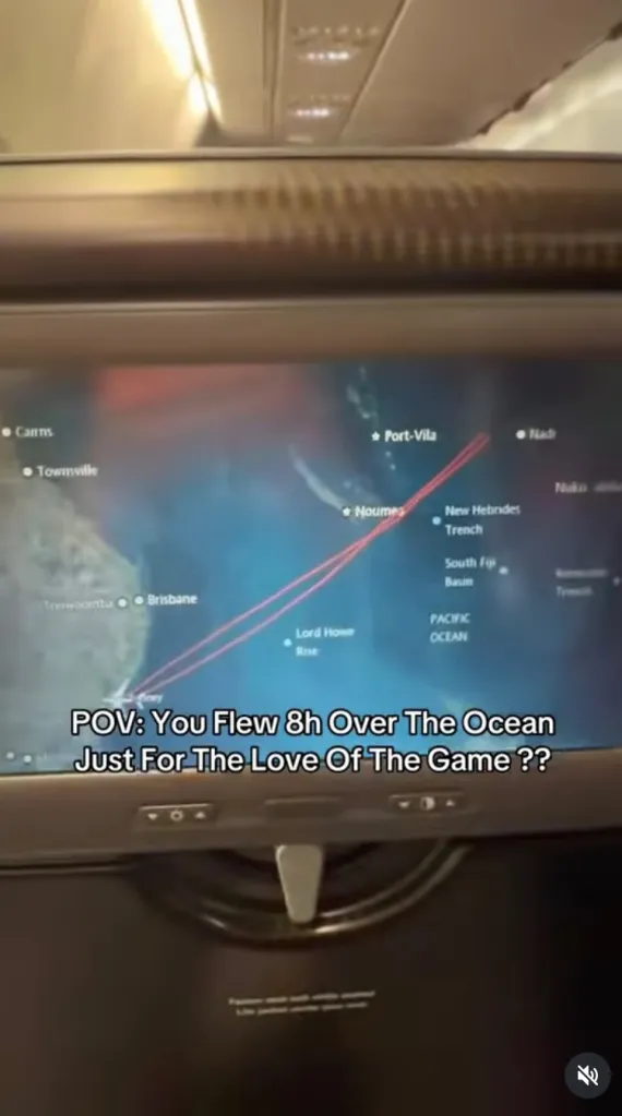 An airplane seatback screen showing a flight path from Australia, over the Pacific Ocean, and turning around mid-flight.