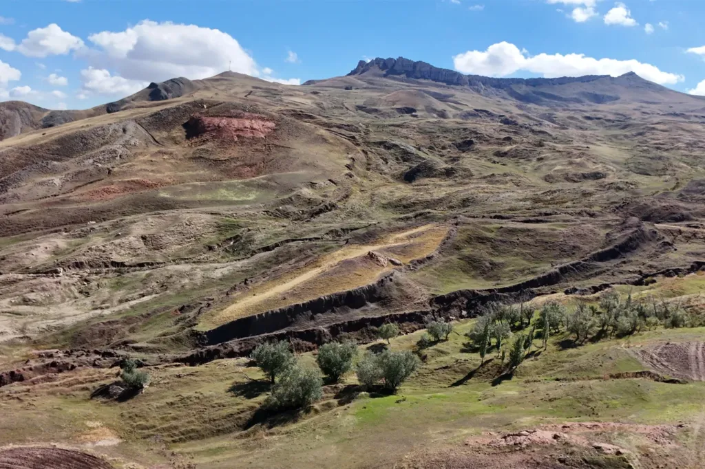 Mountainous landscape with rock formations resembling an ancient boat.