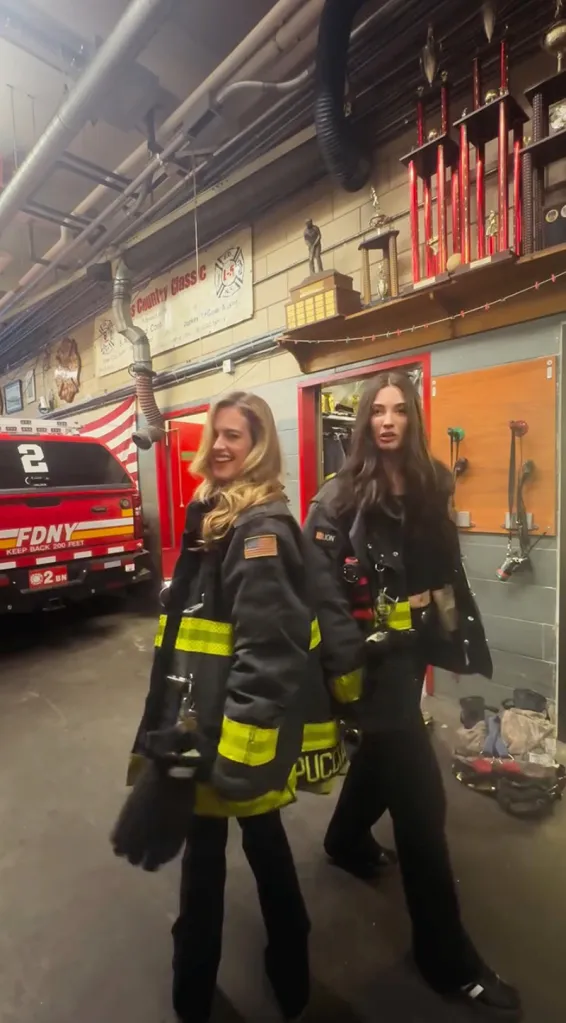 Dana Treacy and Hailey Carlson dancing in firefighter turnout gear at Battalion 2, Engine 24, Ladder 5 fire station.
