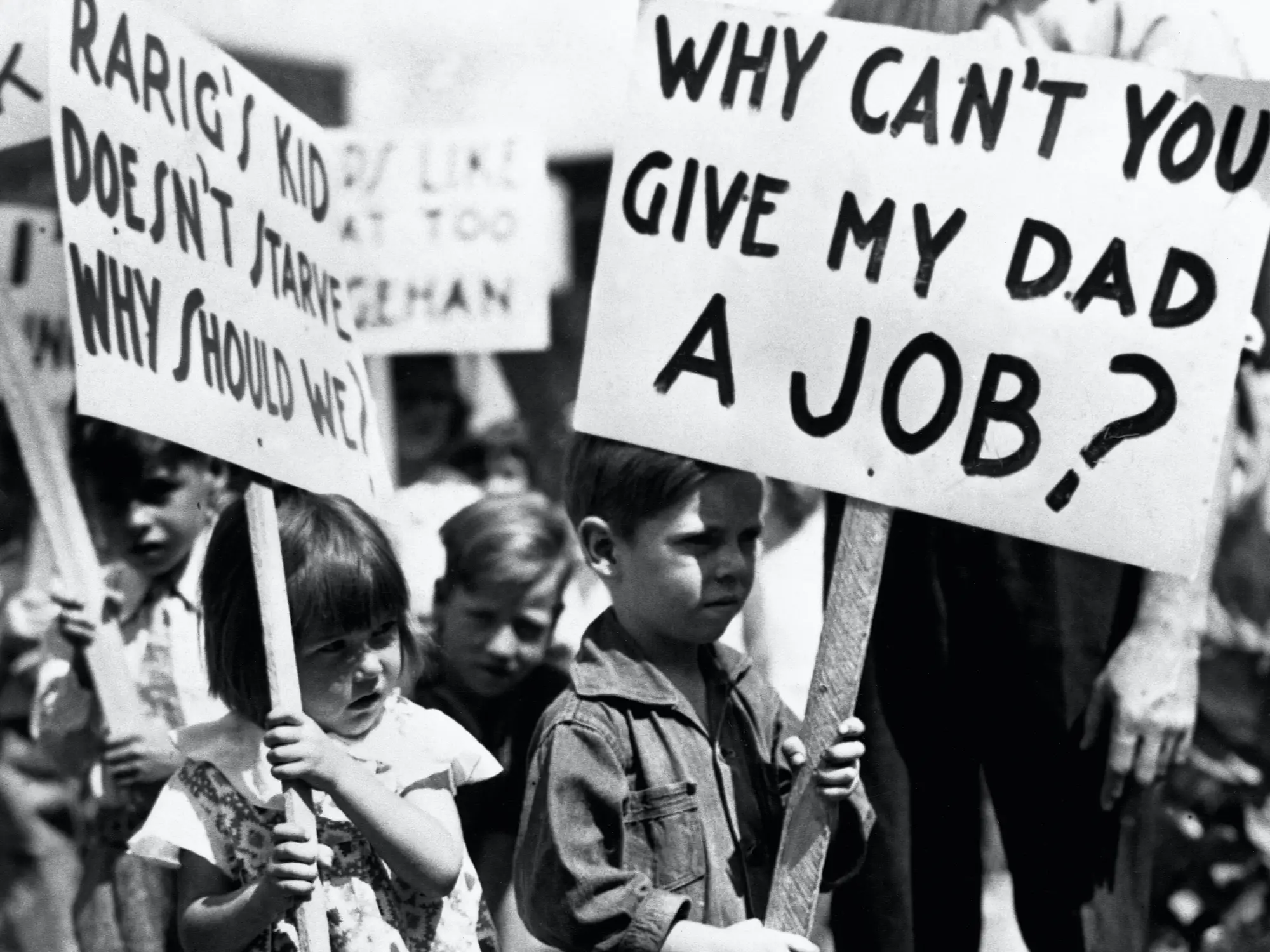 Children at a demonstration during the Great Depression. One child holds a sign reading