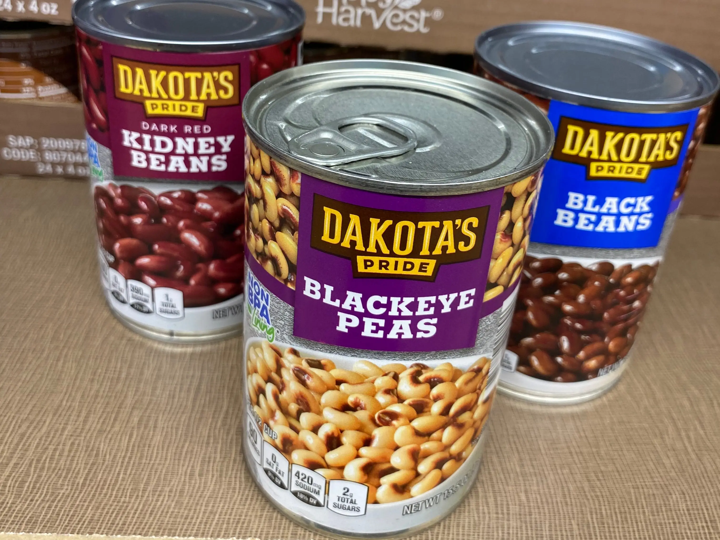 three cans of dakota's pride beans on the shelves at aldi