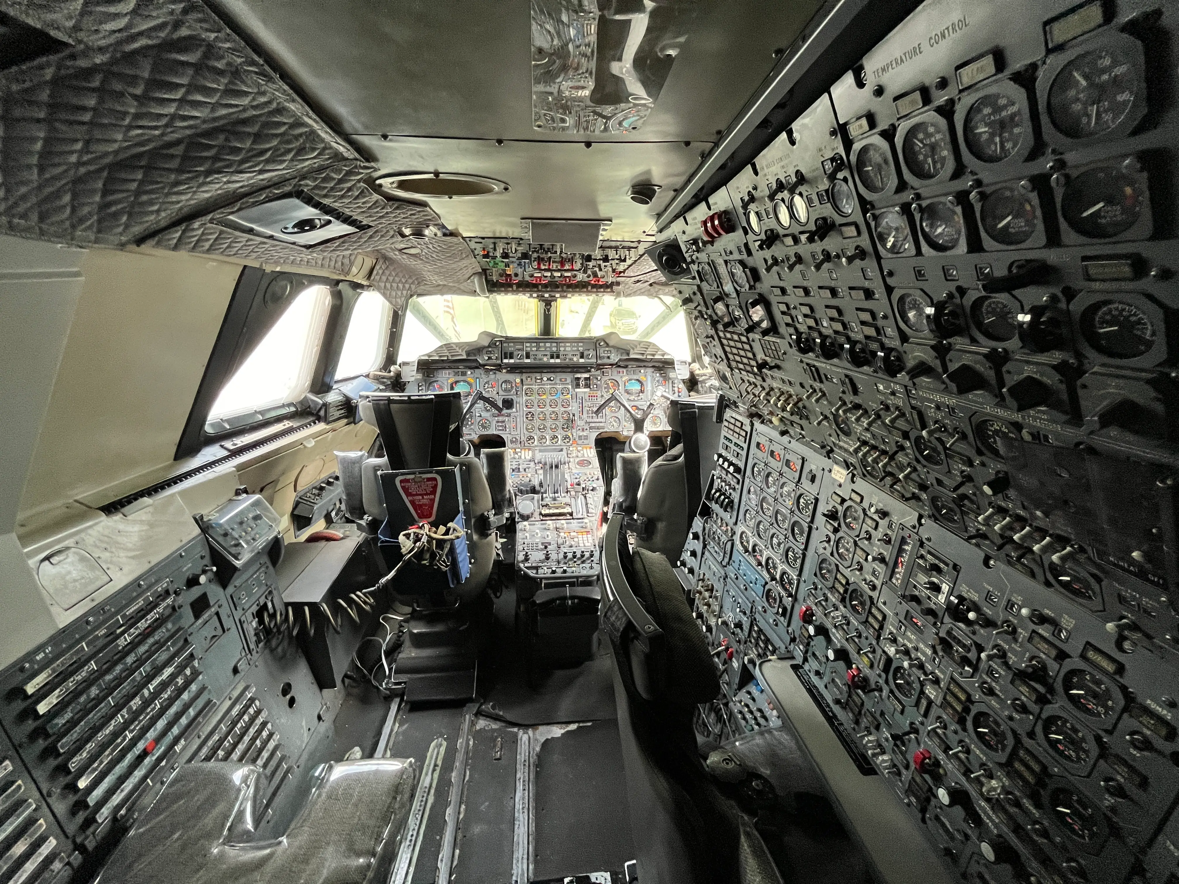 The cockpit of a plane with countless dials and switches.