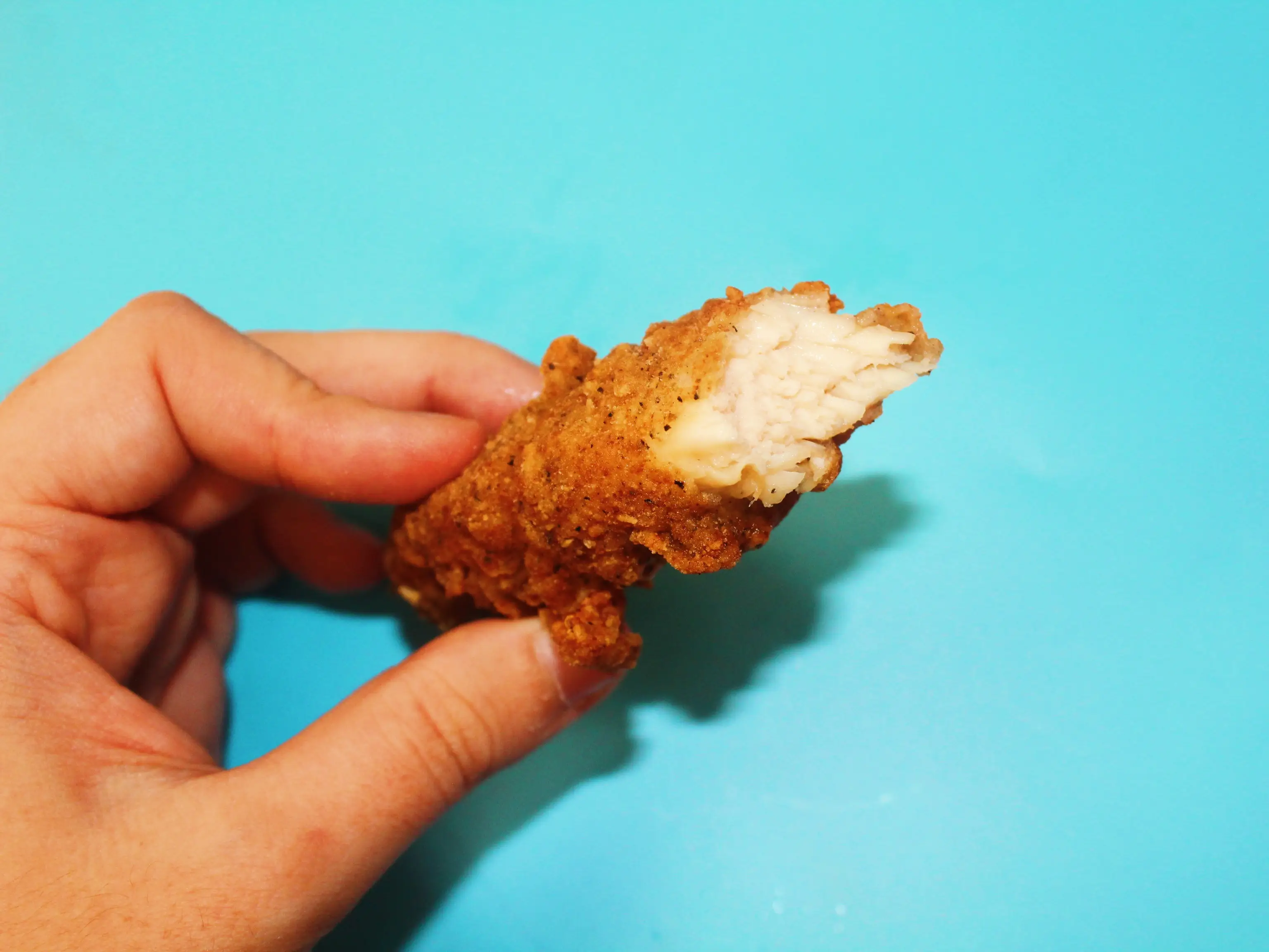 kfc chicken tender bitten into