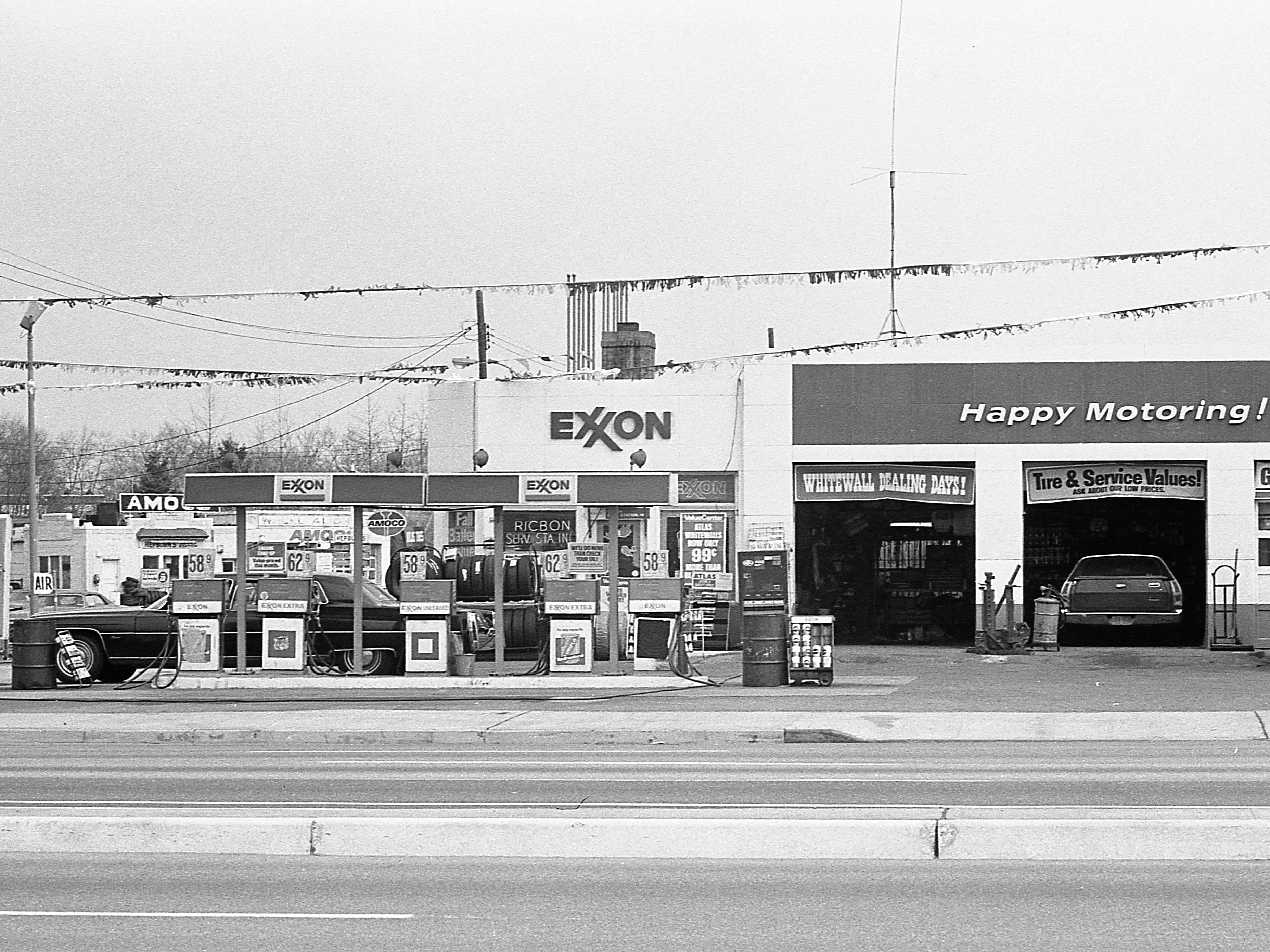 A wide shot of an Exxon Gas Station in New York City, April 1975.