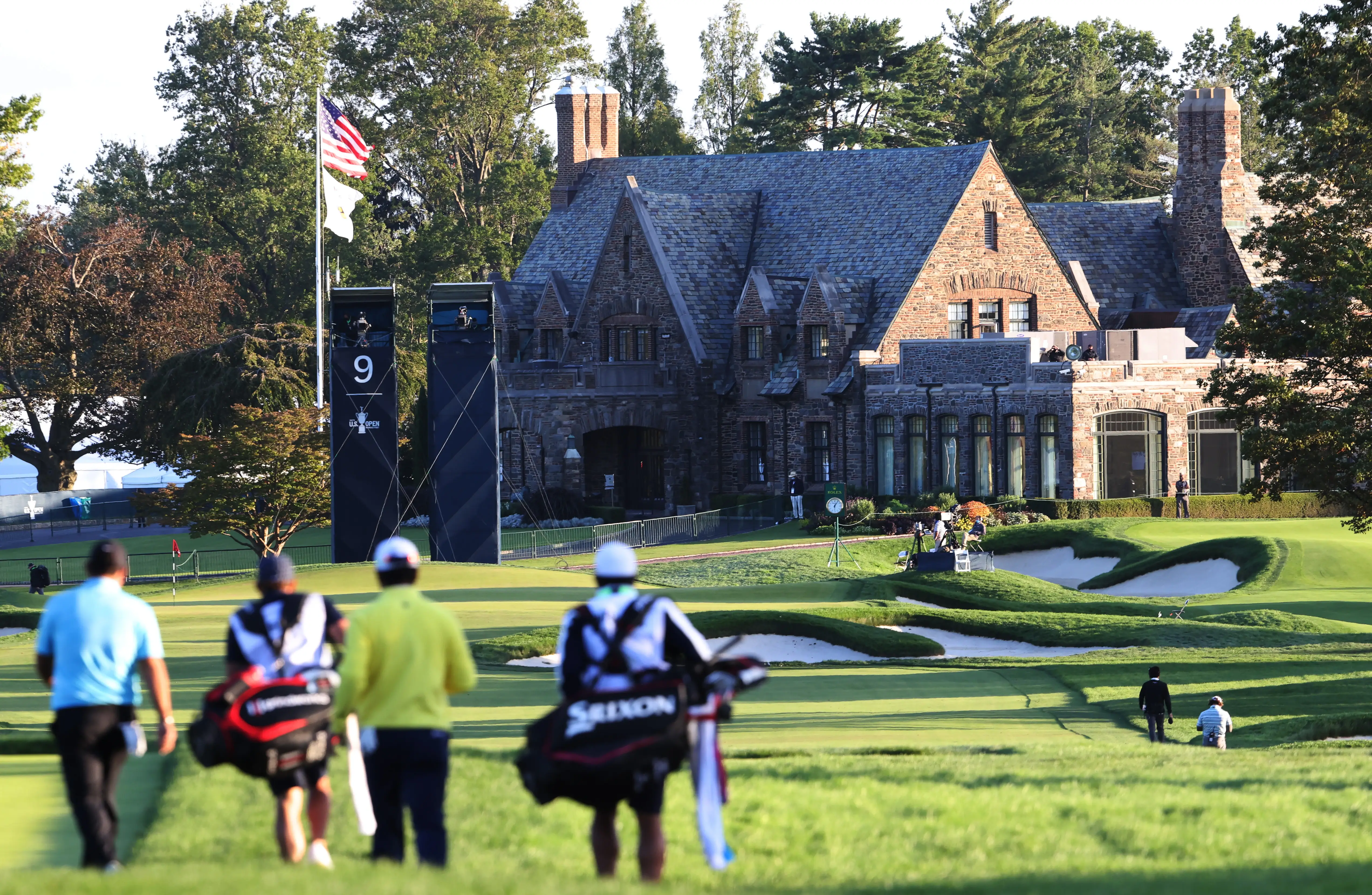 Hideki Matsuyama of Japan and Patrick Reed of the US walked off the ninth tee at Winged Foot Golf Club in Mamaroneck, New York, at the 2020 Open.