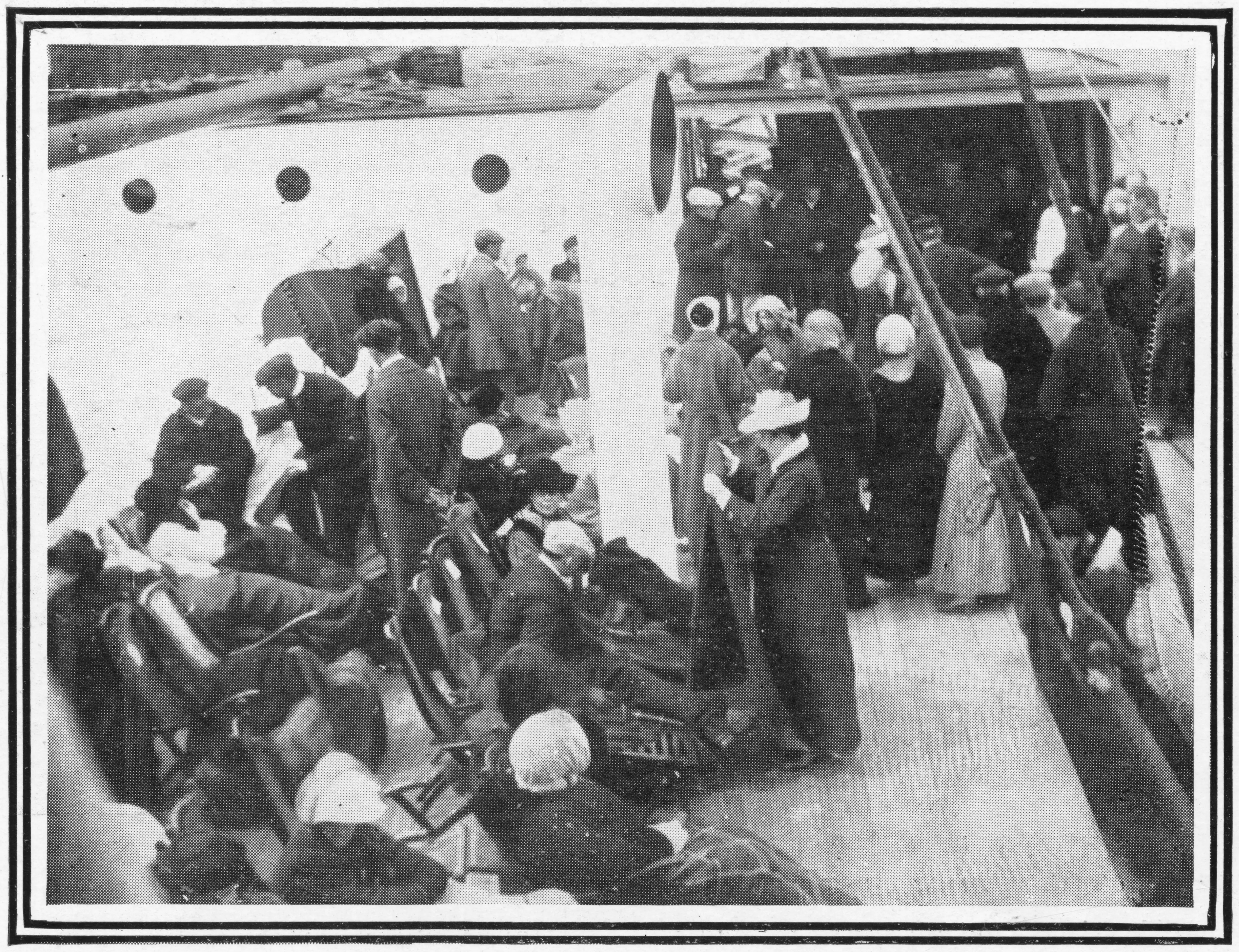 A group of people on the deck of a boat, some seated in chairs
