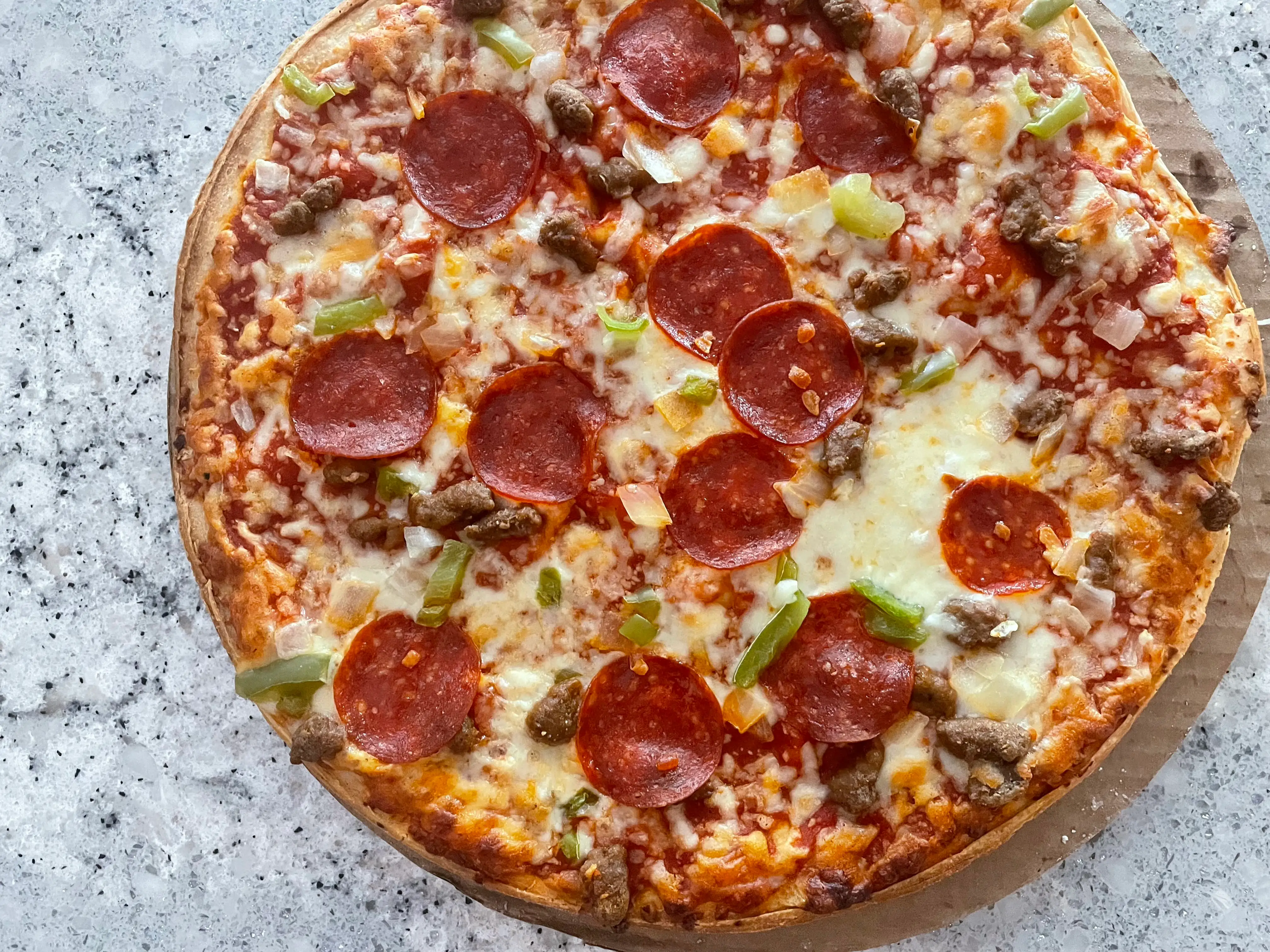 Pizza with cheese, pepperoni, onion, sausage, green pepper