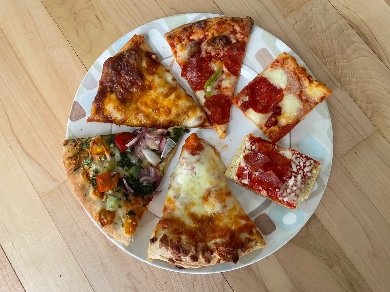 A plate with six slices of different pizzas on it