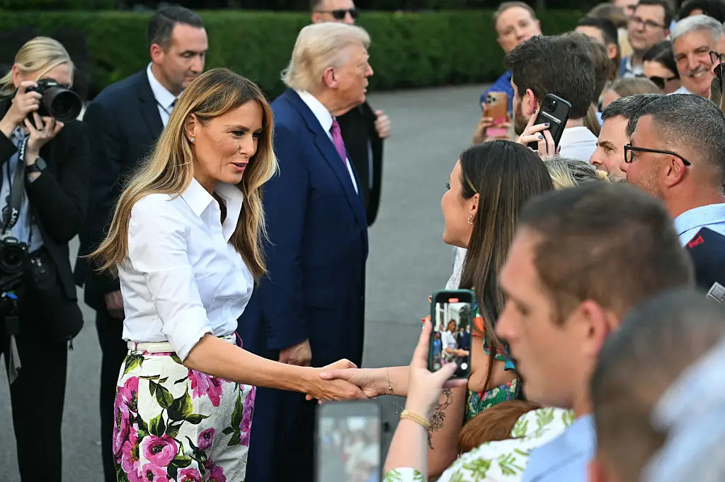 Melania Trump shakes hands with a woman at the Congressional Picnic.