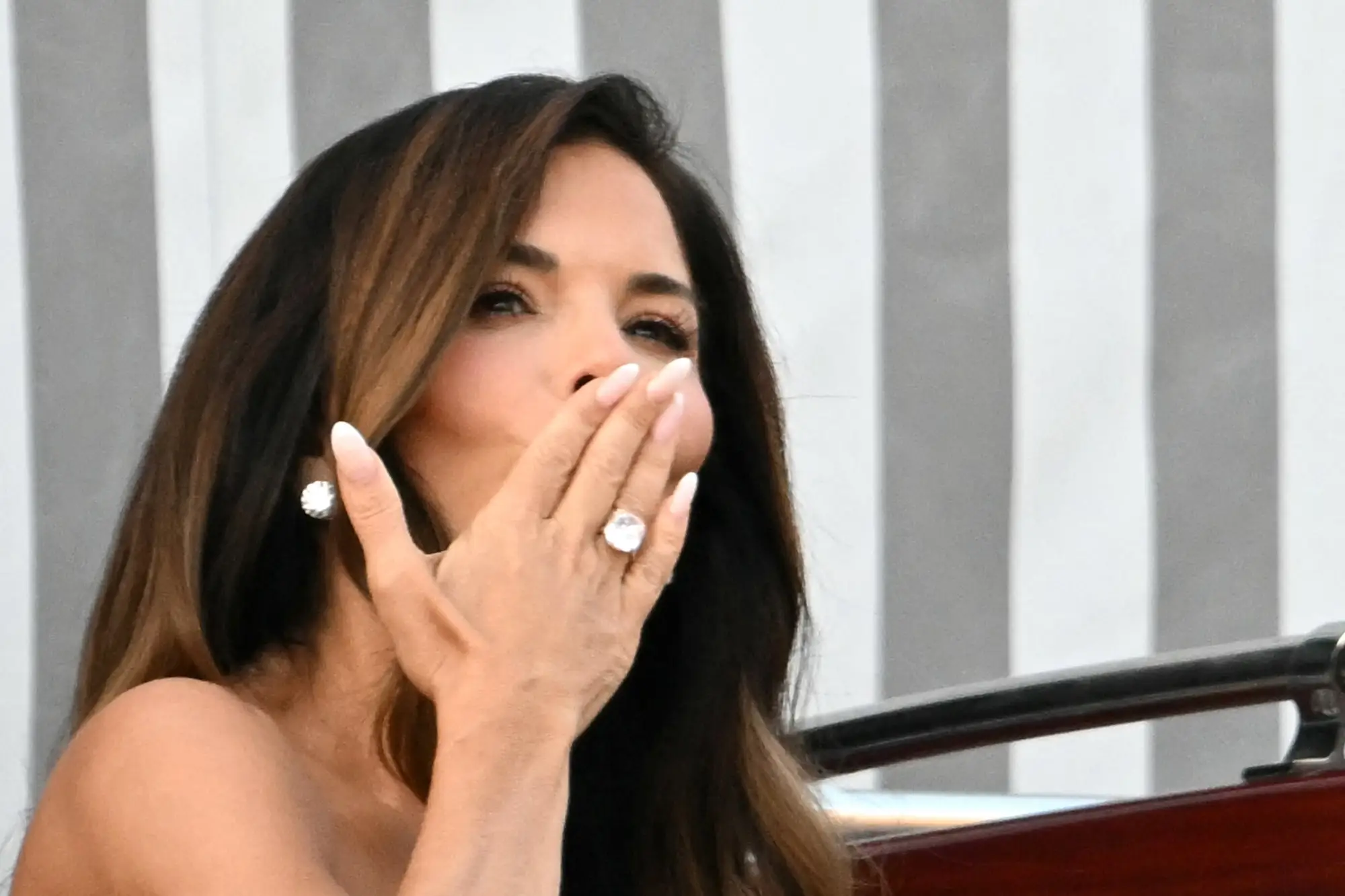 Lauren Sanchez blows a kiss while leaving her Venice hotel during wedding festivities.