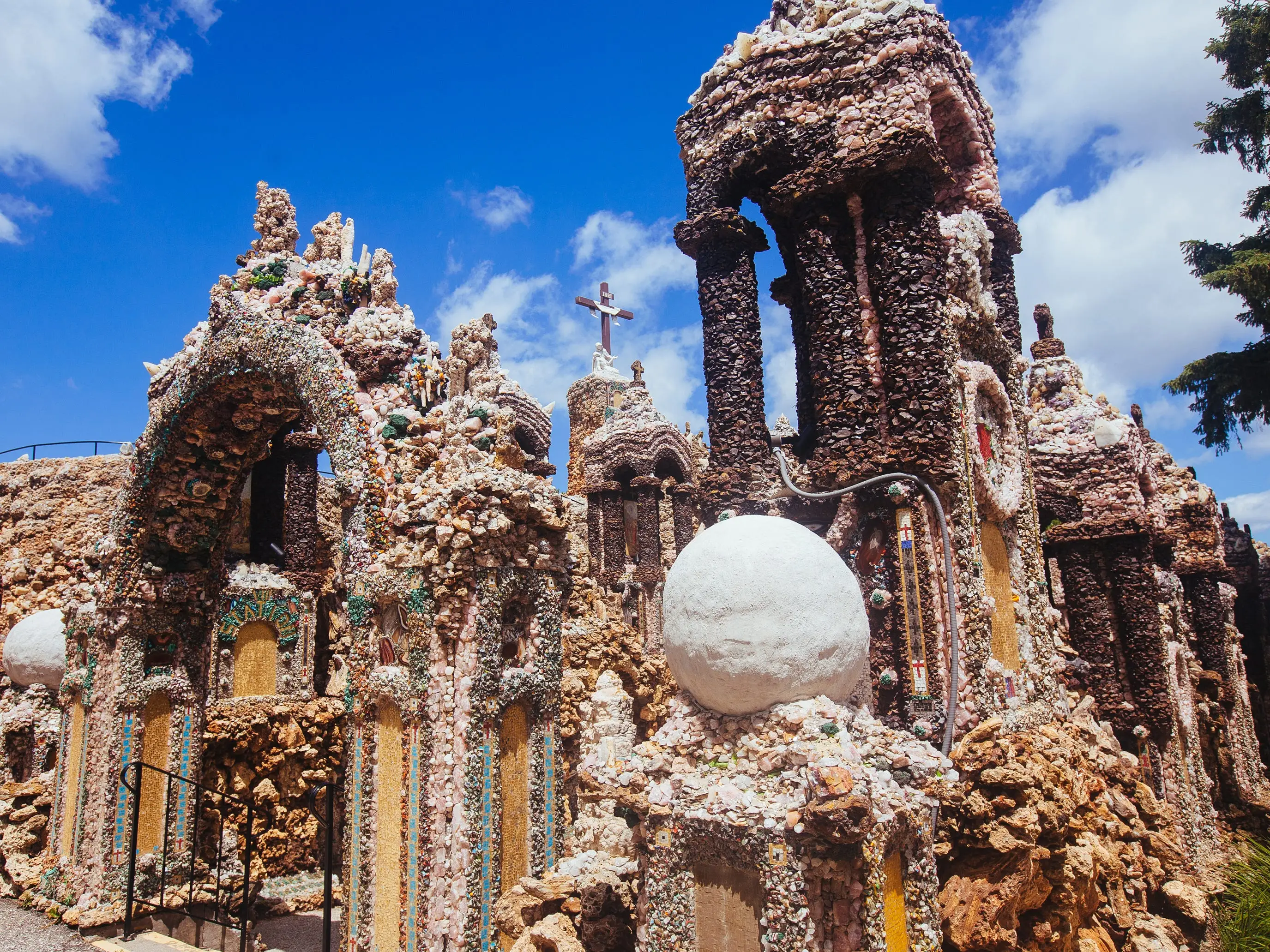 Father Paul Dobberstein promised to build a shrine to the Virgin Mary as she helped cure his grave case of pneumonia. His resulting Grotto of the Redemption in West Bend is made of rocks, shells, fossils, and gems pressed into concrete. It's the size of a football field.