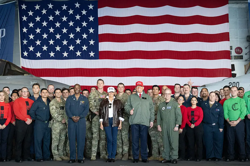 Melania Trump and Donald Trump with Navy sailors.