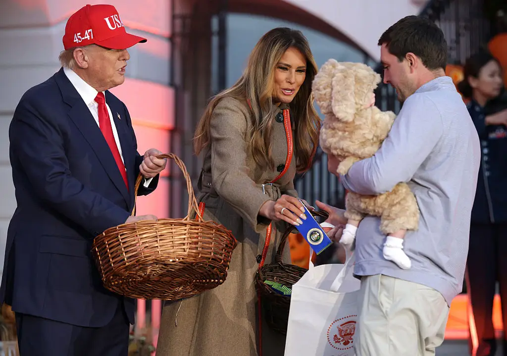 Donald Trump and Melania Trump hand out candy at the White House for Halloween.