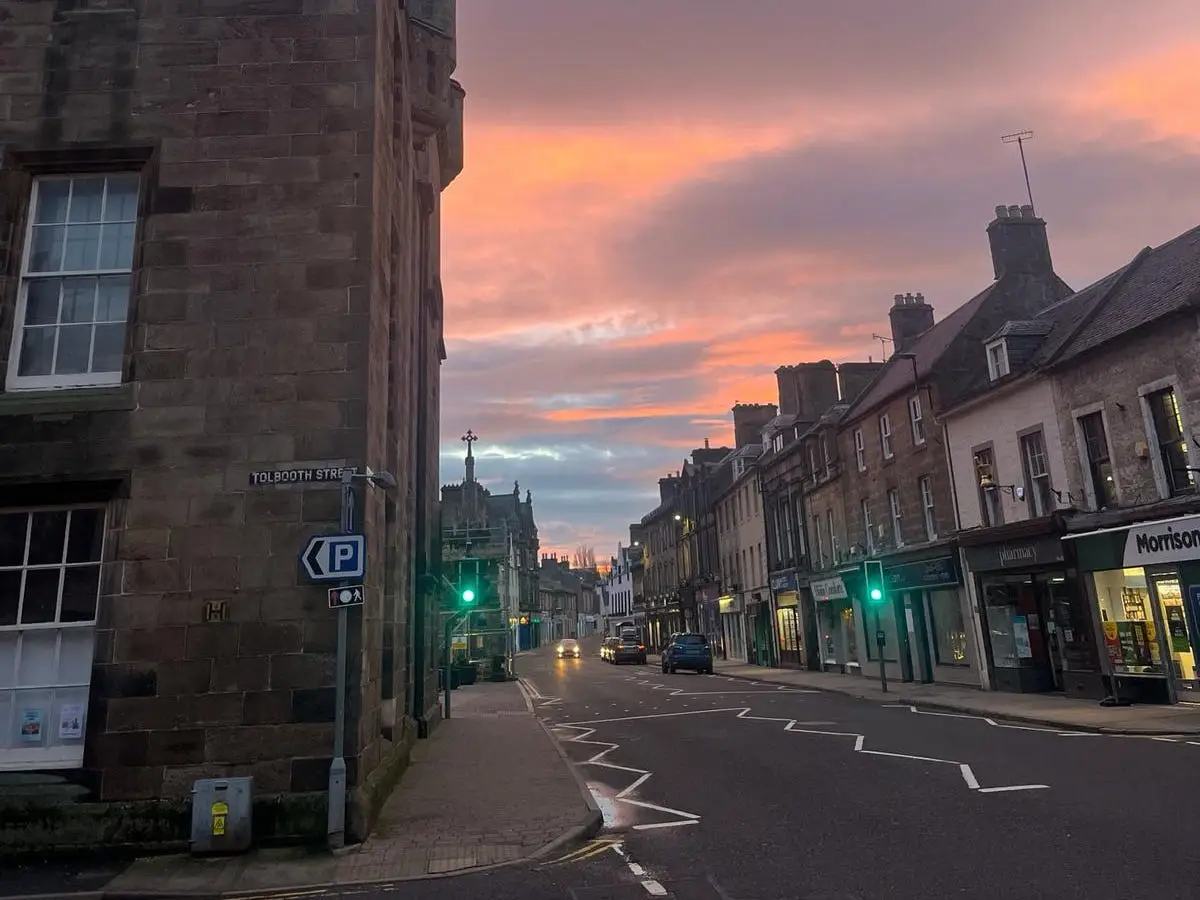 View of town with orange and purple skies