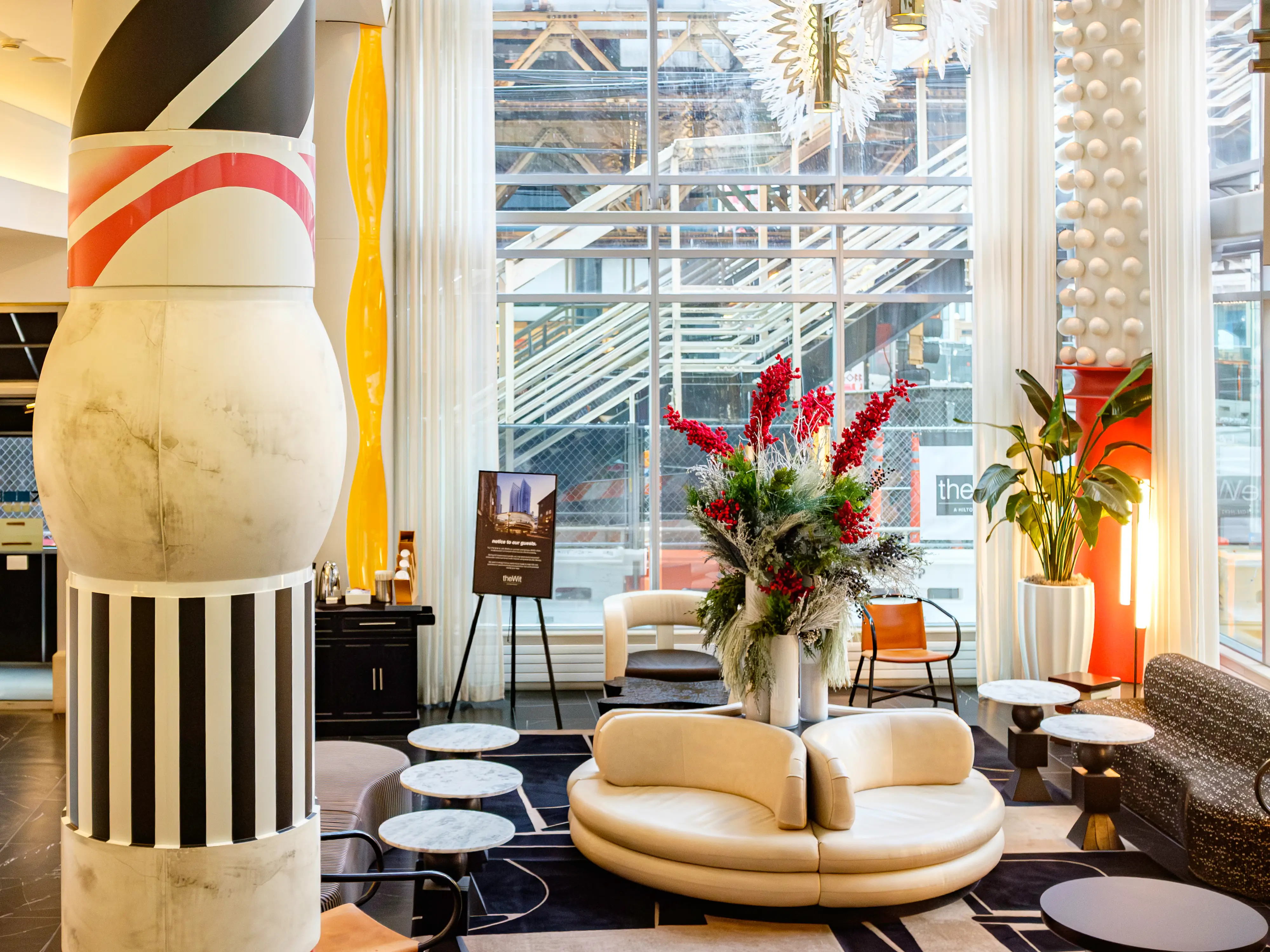 Inside the vibrant lobby at the Wit hotel with whimsical pillars and furniture