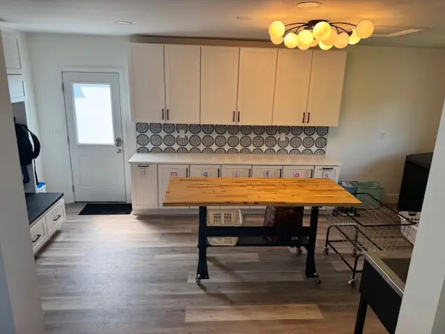 Row of cabinets and large folding table in laundry room