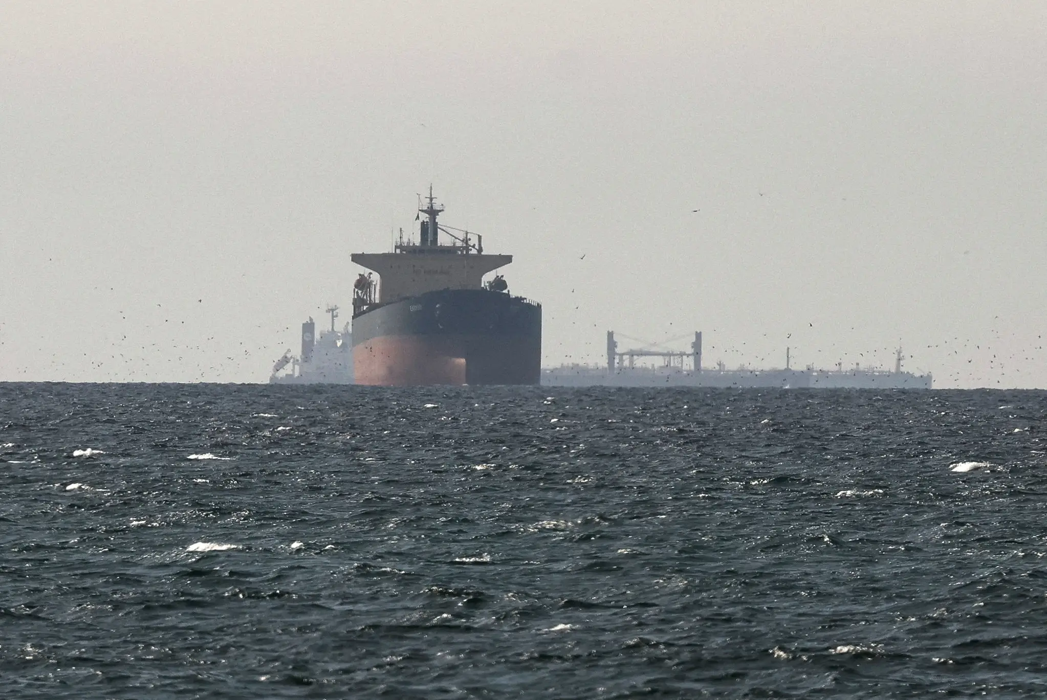 Ships travel through the Persian Gulf near the Strait of Hormuz as the ongoing conflict with the US, Israel, and Iran disrupts trade in the region.
