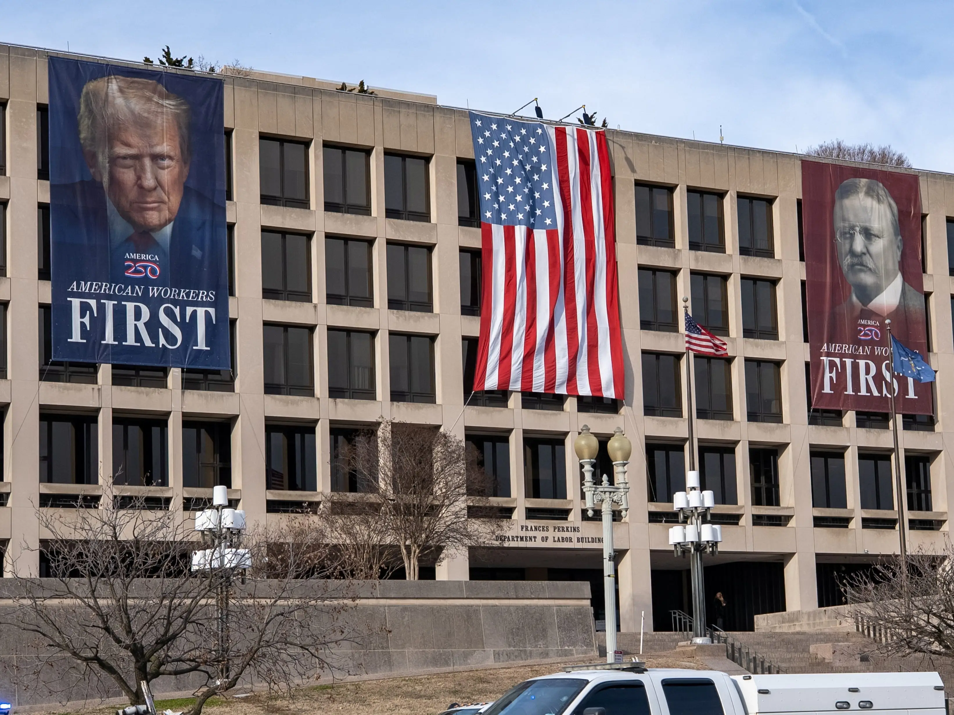 A banner depicting US President Donald Trump is seen on the face of the Labor Department building near the US Capitol ahead of Trump's State of the Union speech in Washington, DC, on February 24, 2026.