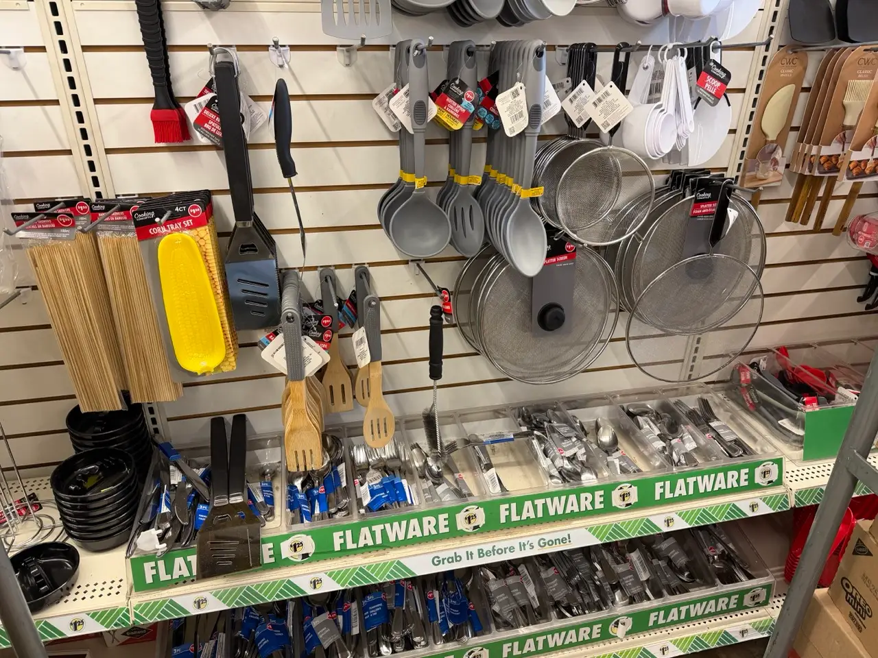 Kitchen utensils like spoons, forks in kitchen section of at Dollar Tree