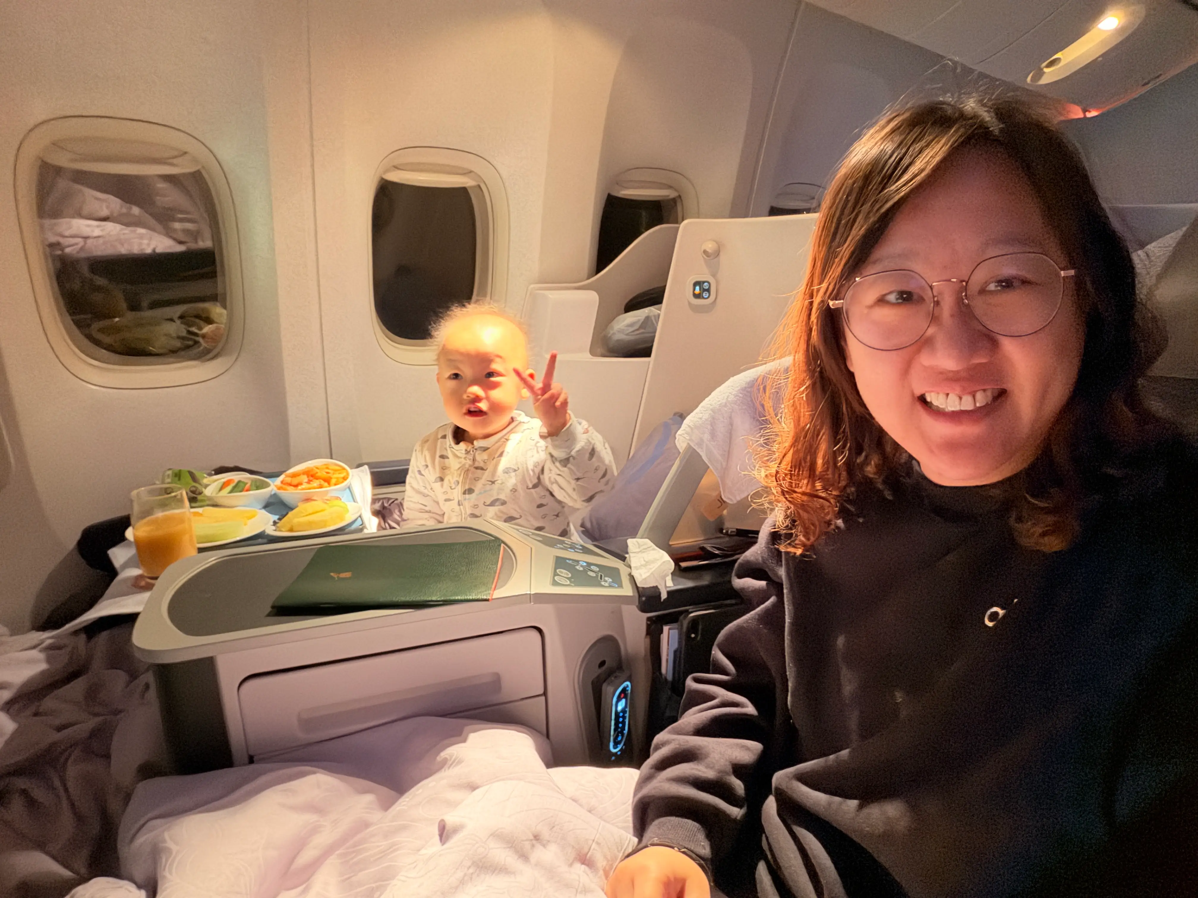 Mother and daughter are sitting on a plane.