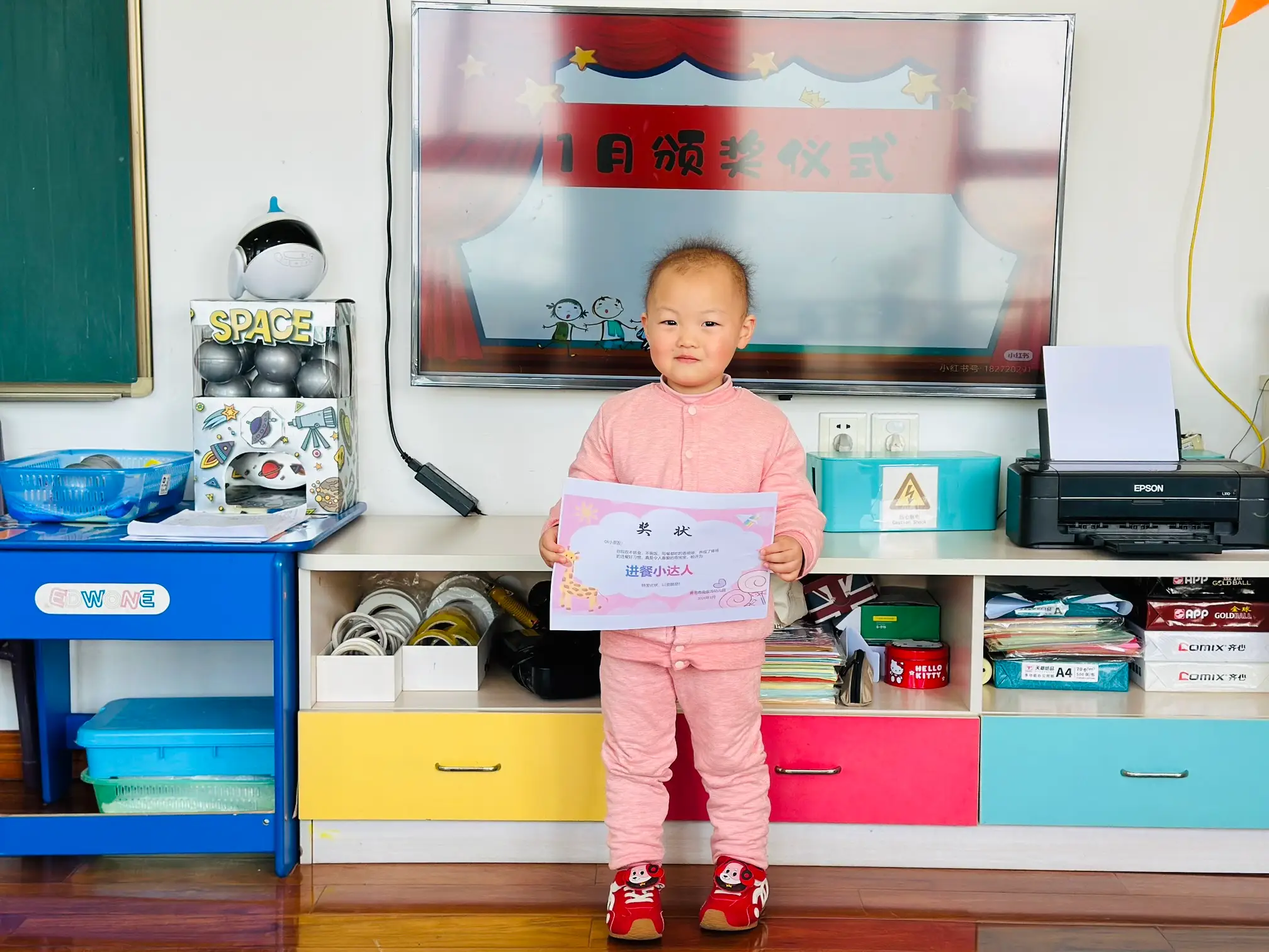 A preschooler receiving an award at a school in China.