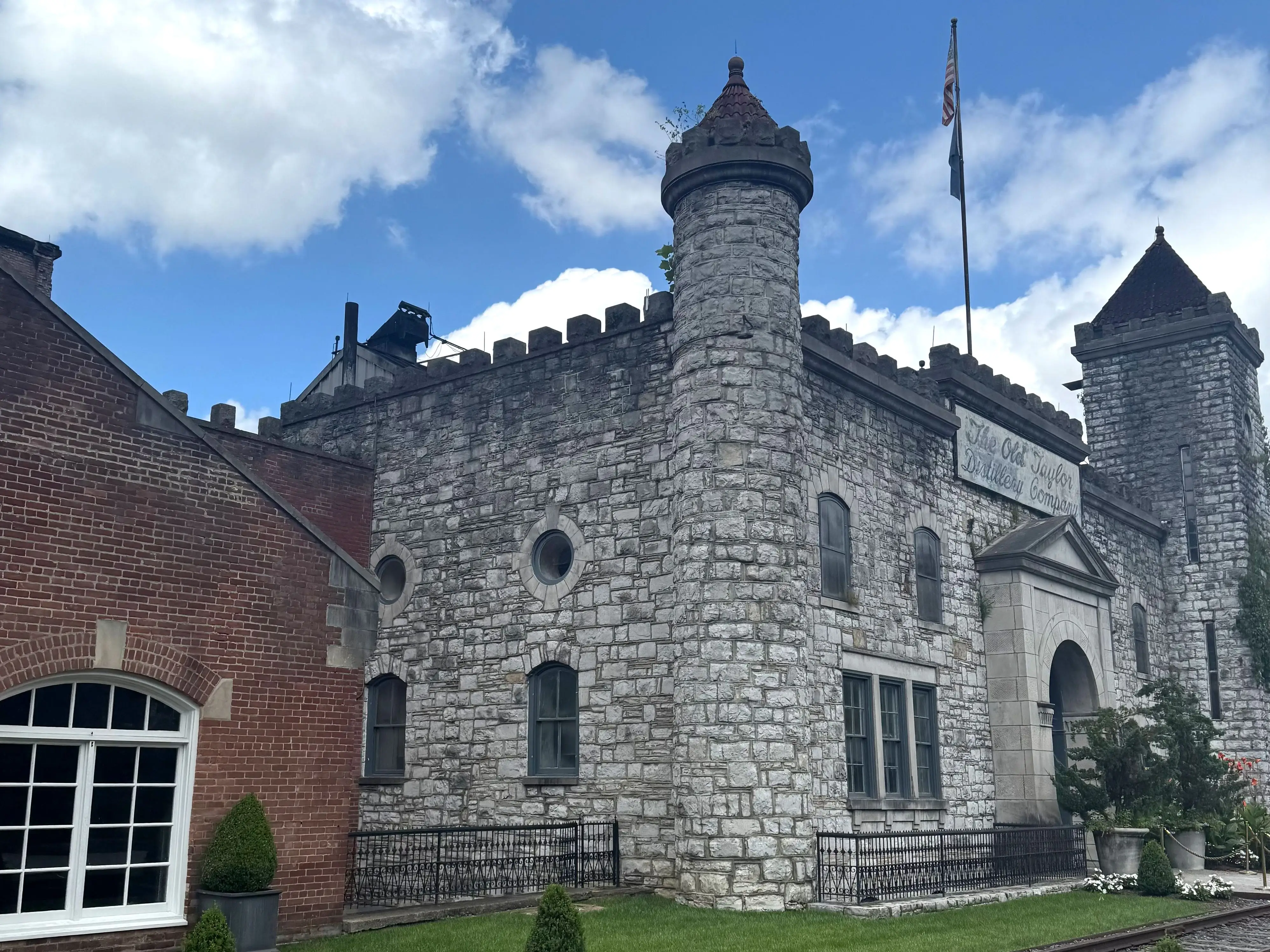 The exterior of a distillery that looks like a castle.
