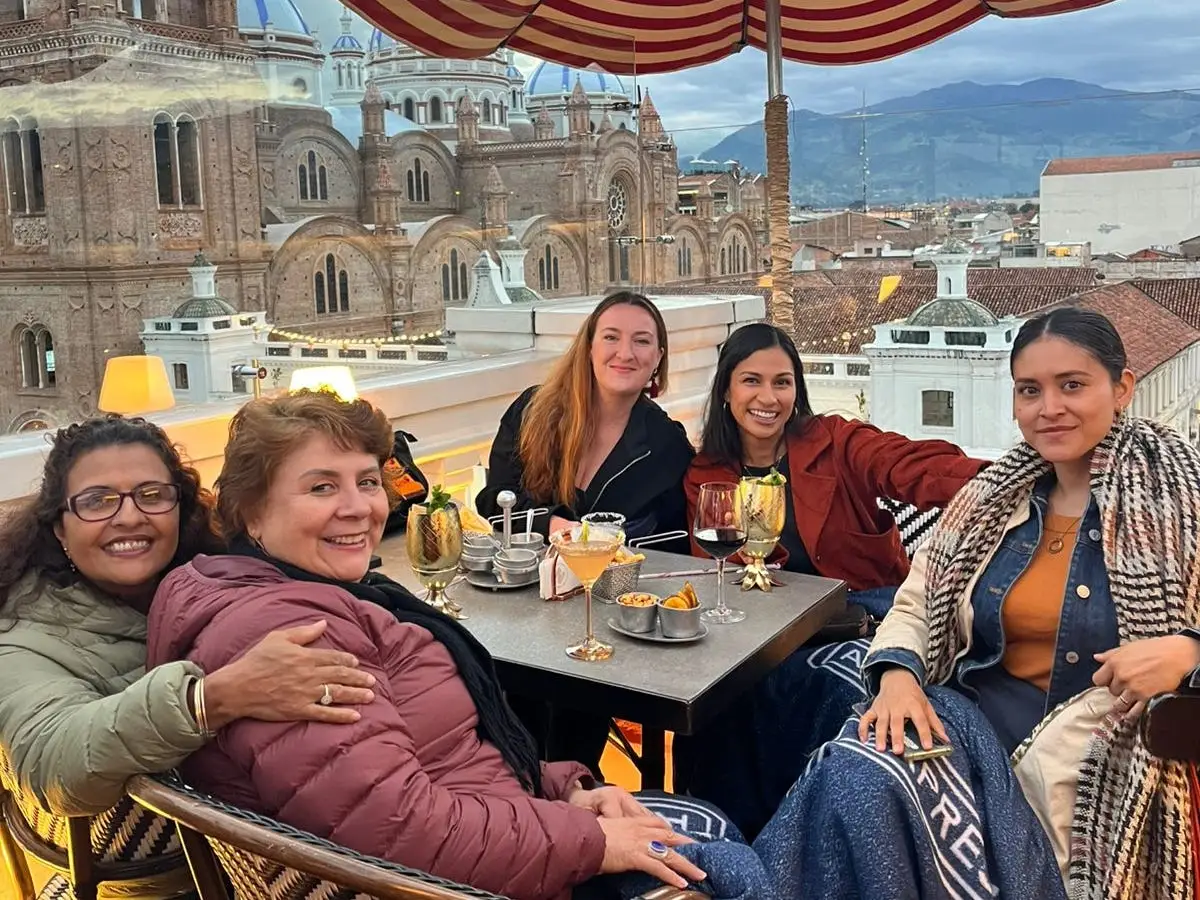 A group of women having drinks at a table in South America.