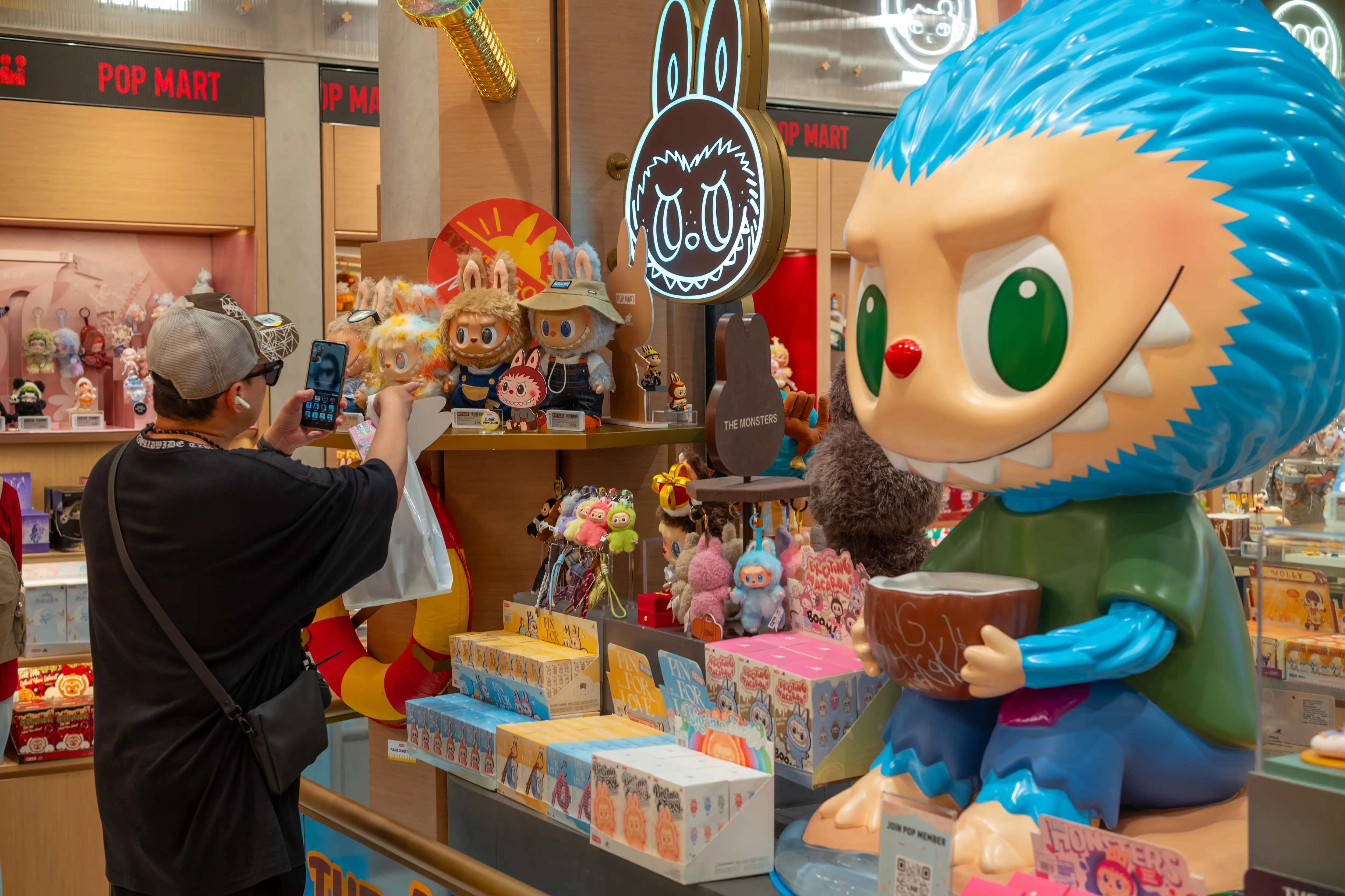 A customer is seen checking Labubu toys at the Pop Mart shop in the Mega Bangna shopping mall.