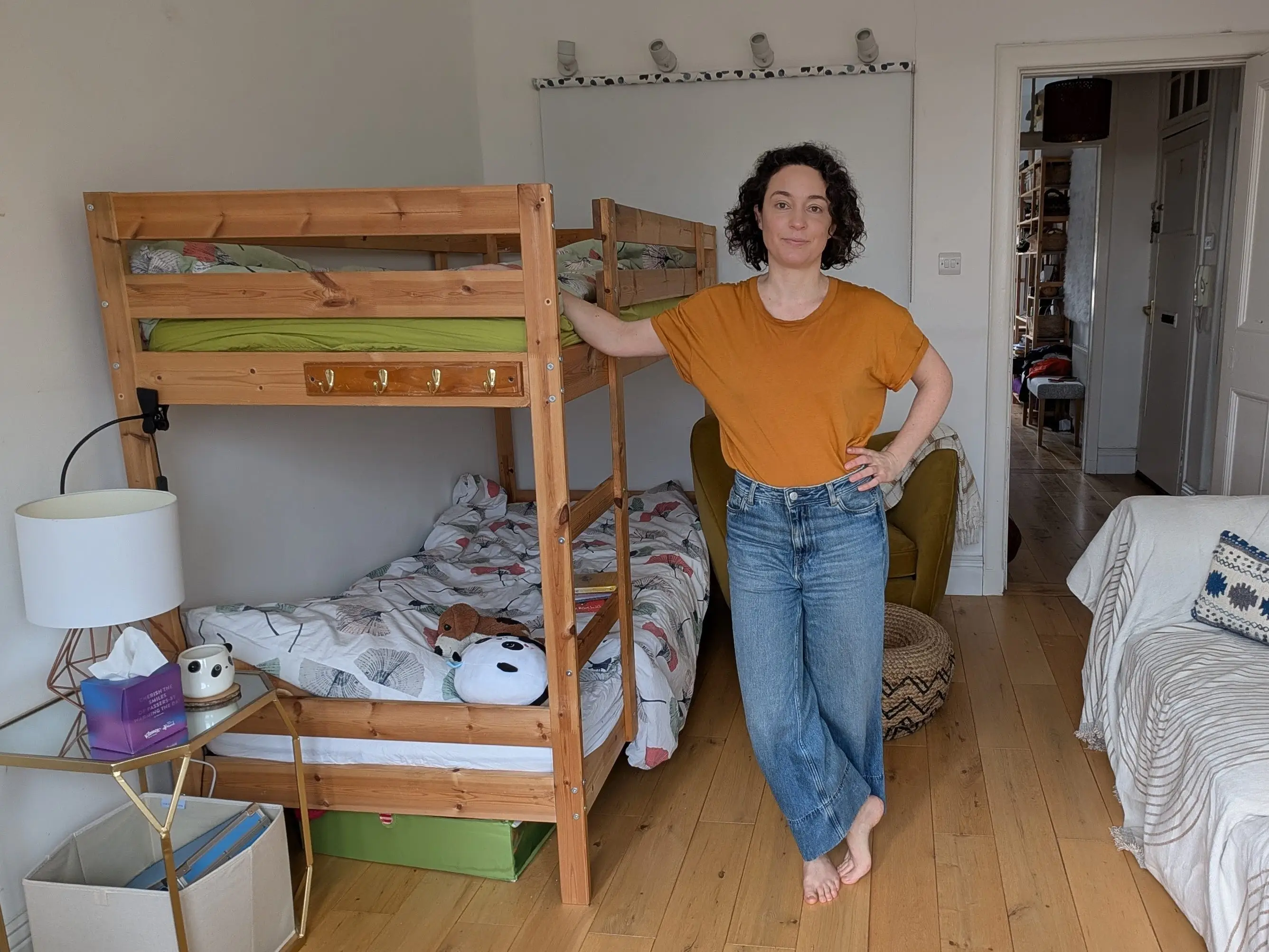 Woman posing next to bunk beds