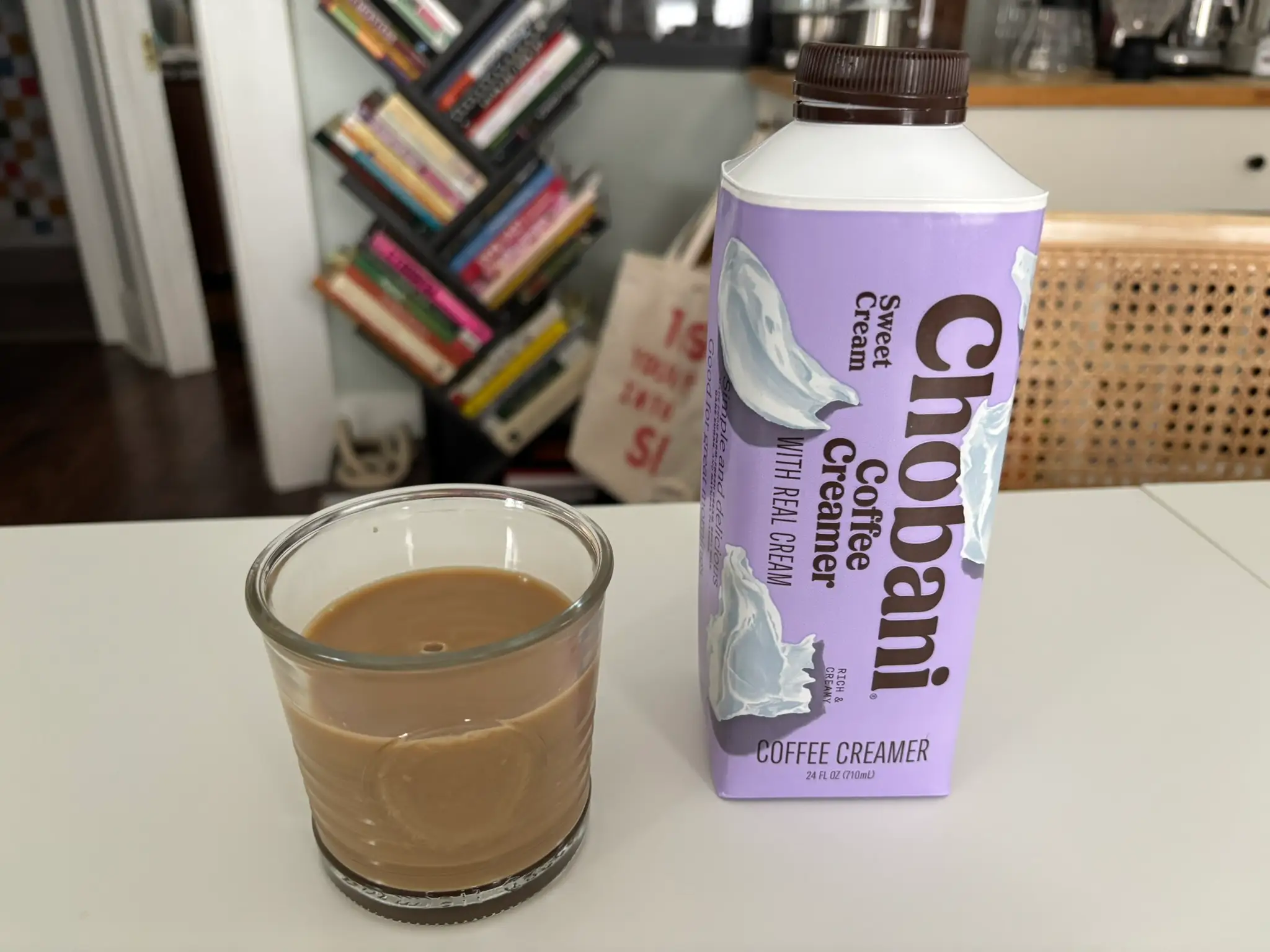 Chobani sweet-cream creamer next to cup of coffee with cream in it