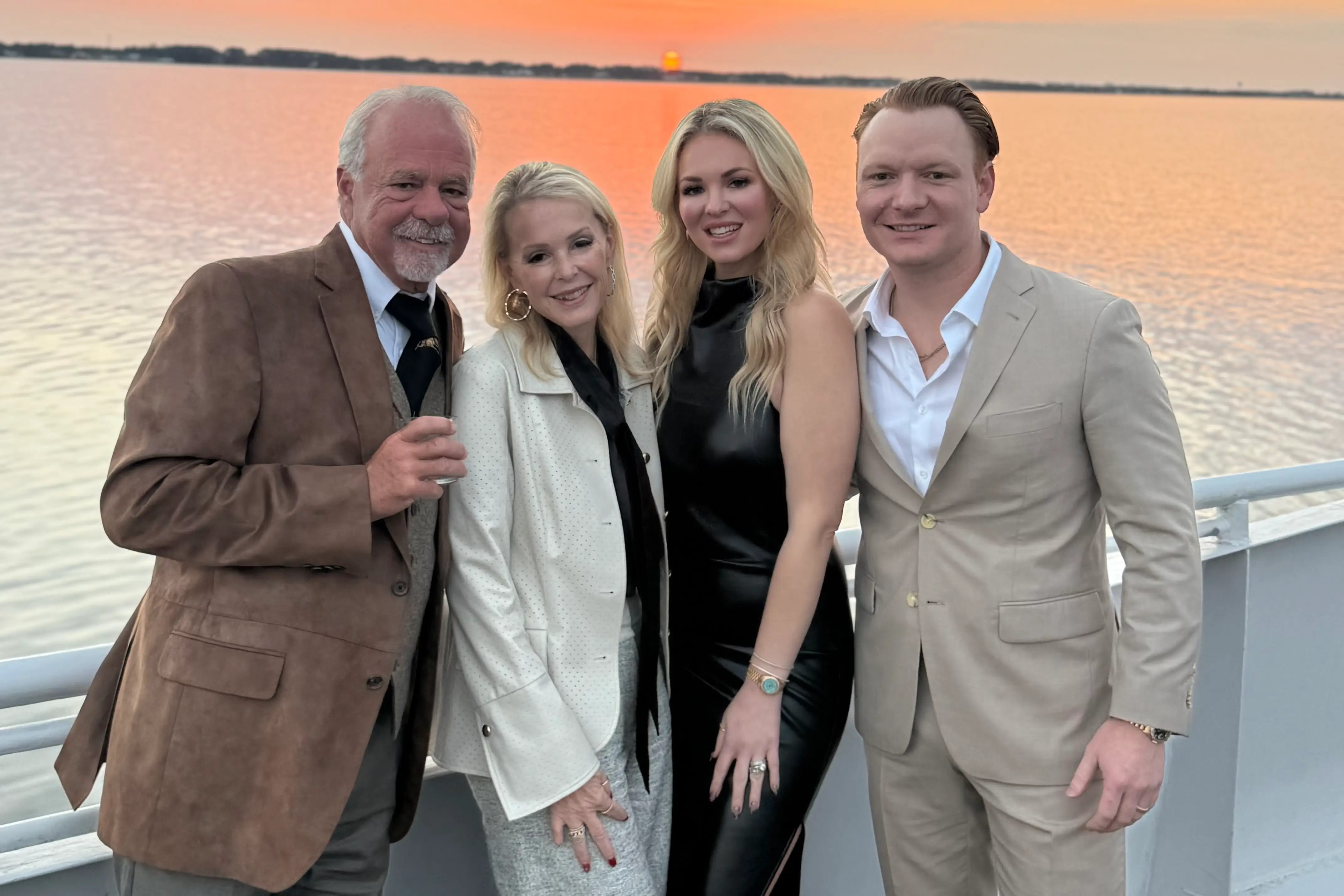 Family posing for photo by the water