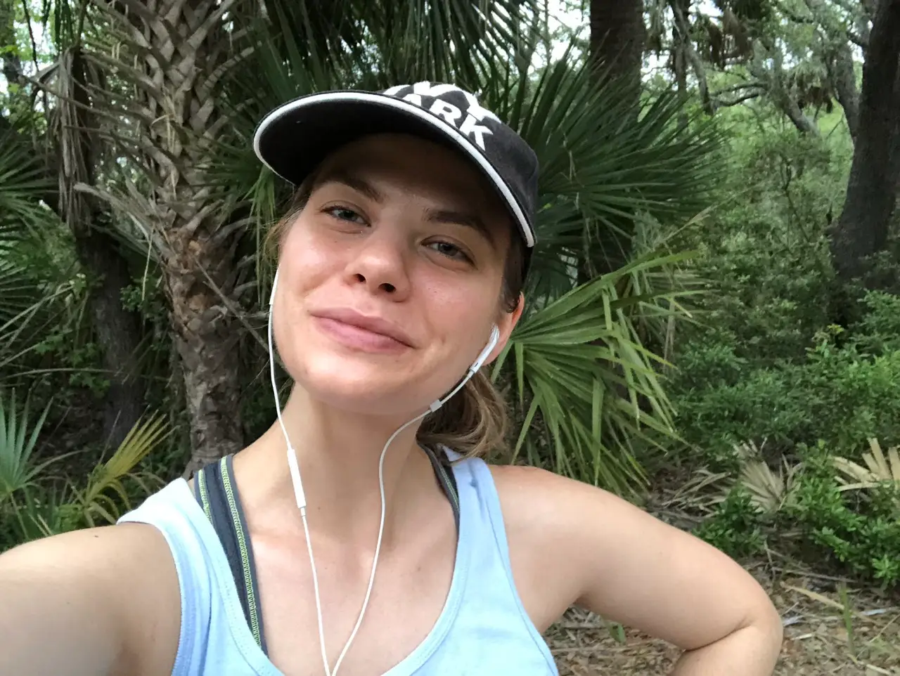Author Kasia Kovacs smiling in selfie in front of trees