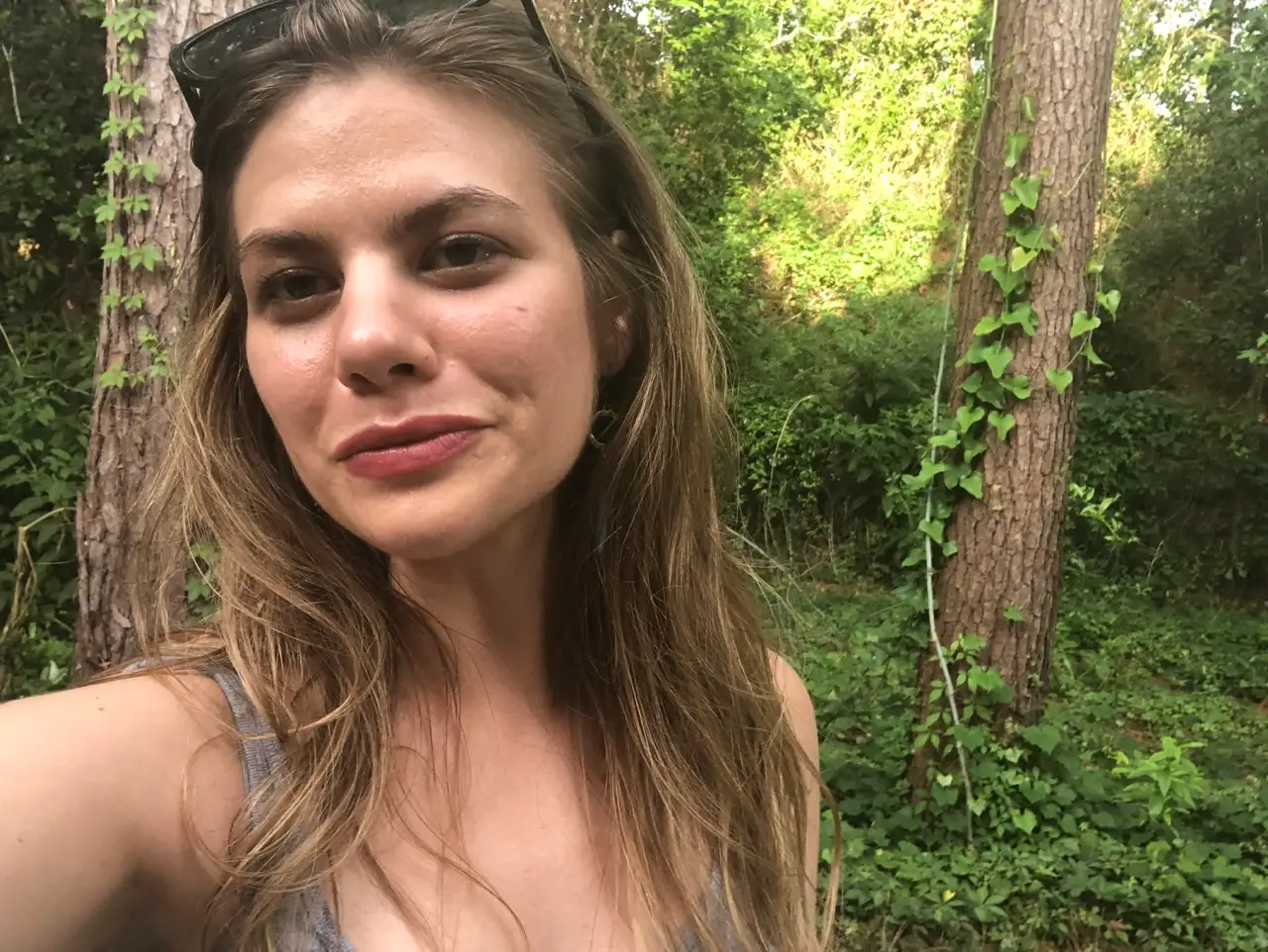 Author Kasia Kovacs smiling in selfie in front of trees