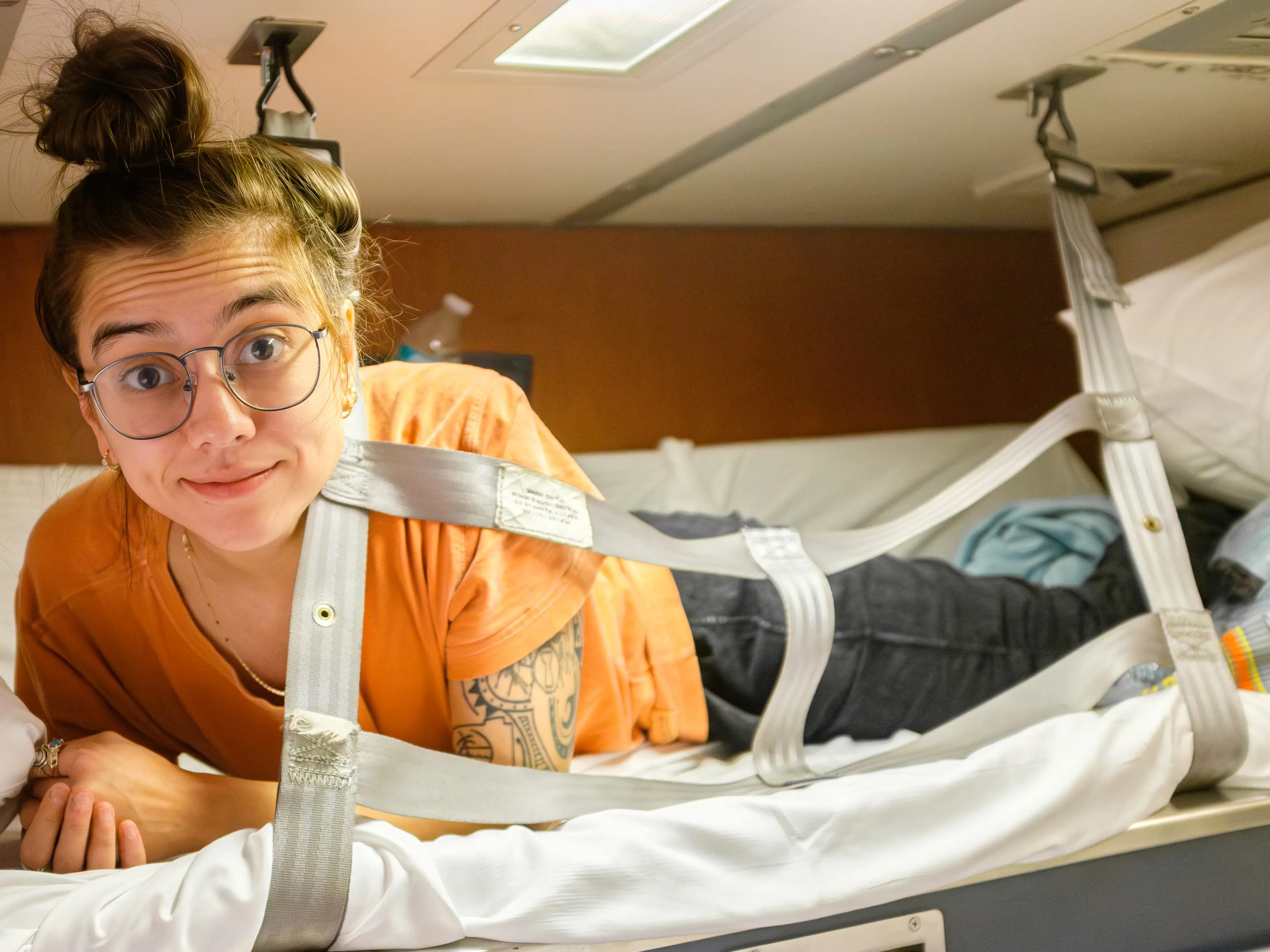 The author lies smiling in the top bunk in the Amtrak bedroom