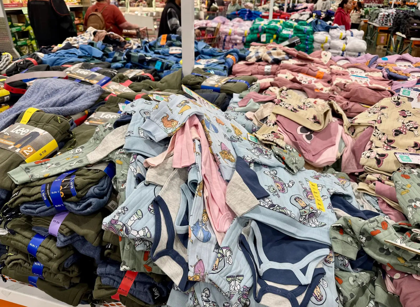 Piles of baby and toddler clothes from Costco.