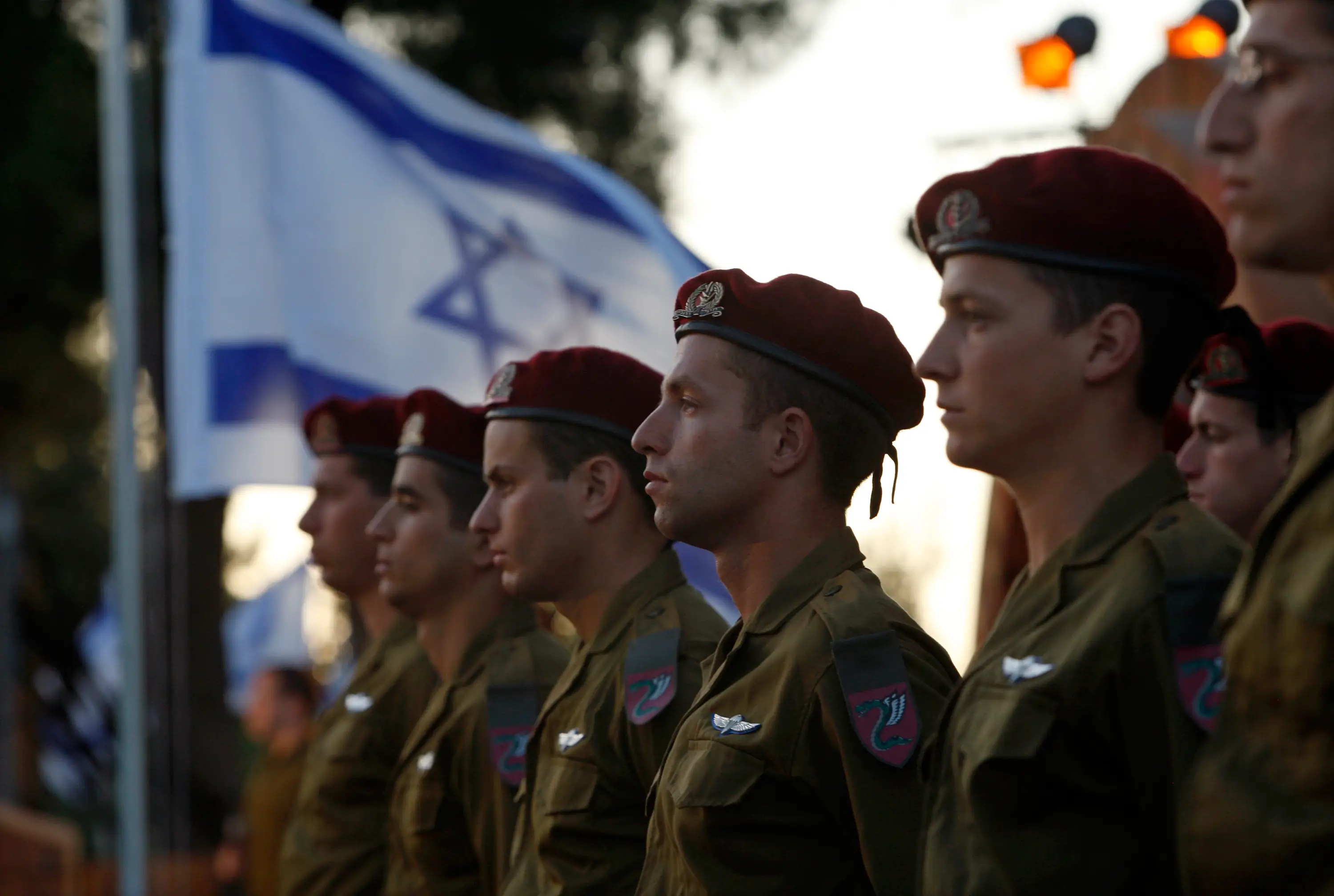 IDF soldiers in front of an Israel flag.