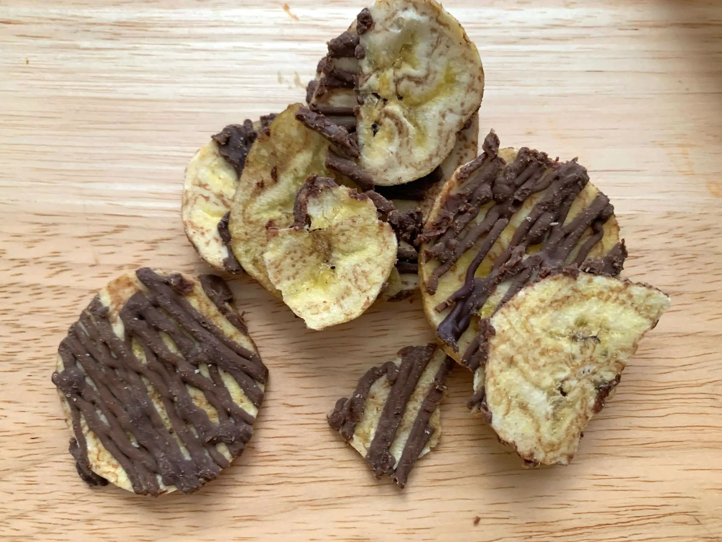 Plantain chips with a dark-chocolate drizzle on top.