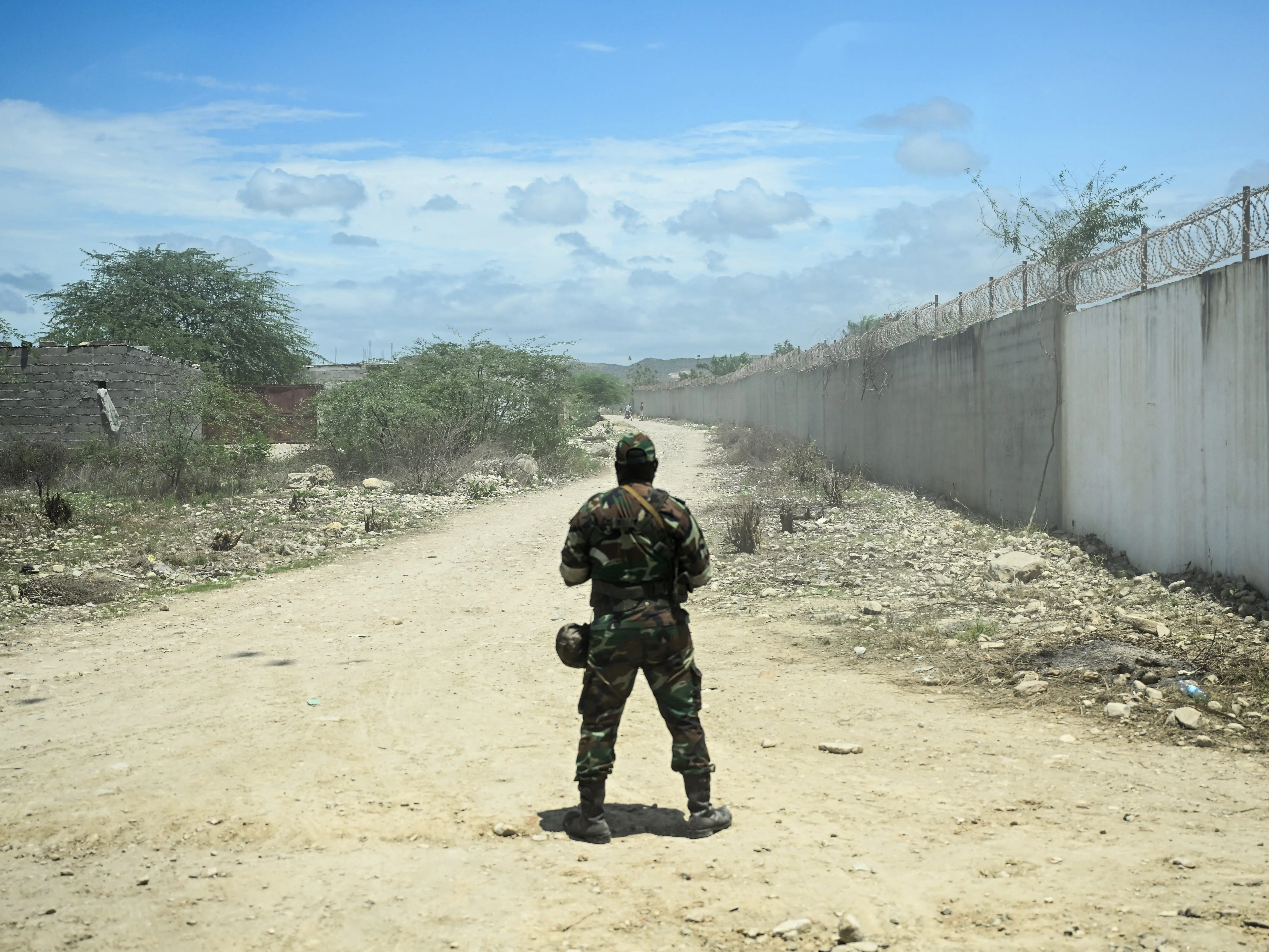 A member of the Angolan security forces monitors an empty road.