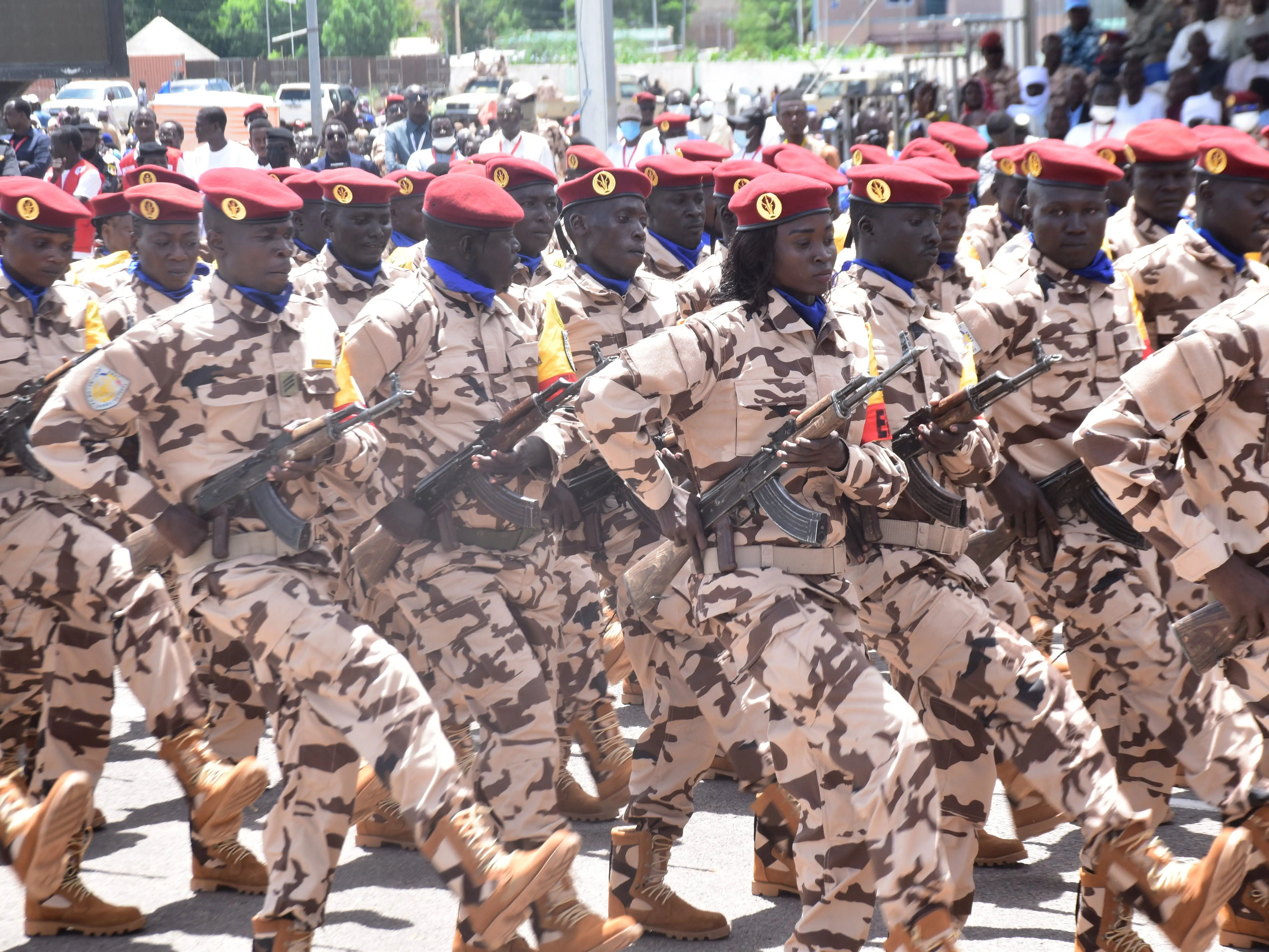 Chad's defense forces march during an Independence Day parade in uniform with rifles.