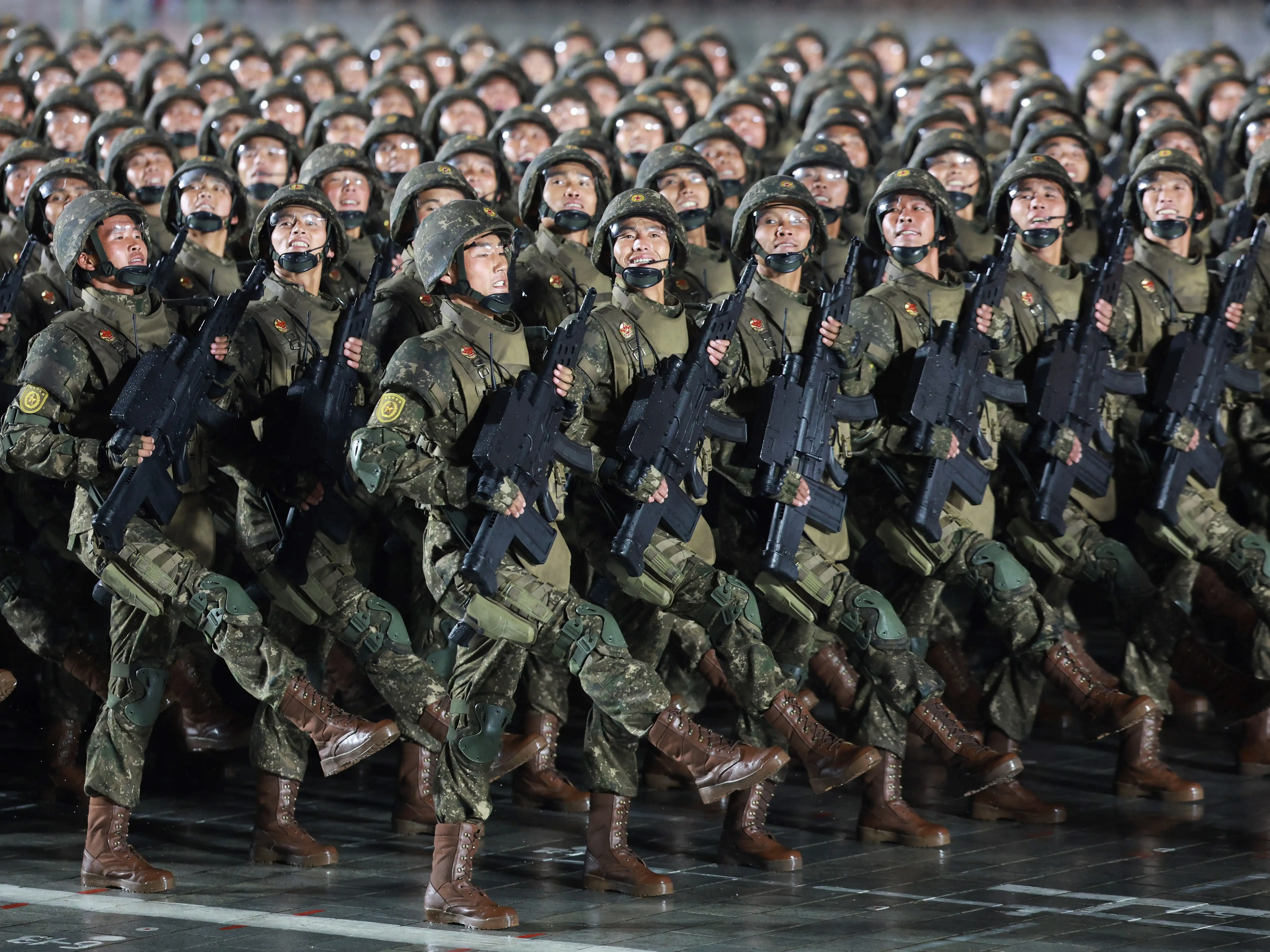 Soldiers march with rifles during a North Korean military parade.