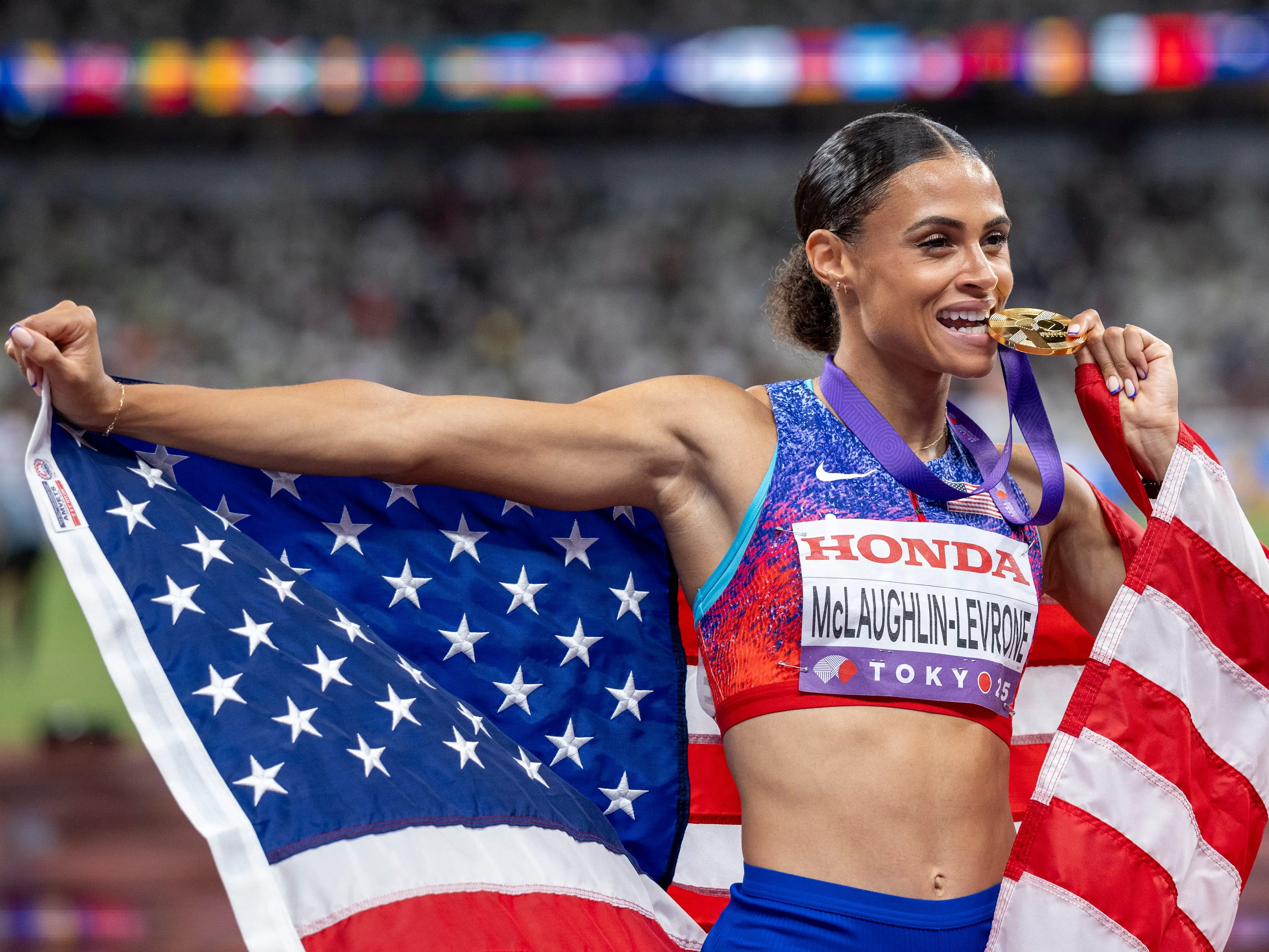 A US athlete at the Olympic Games playfully biting on her gold medal